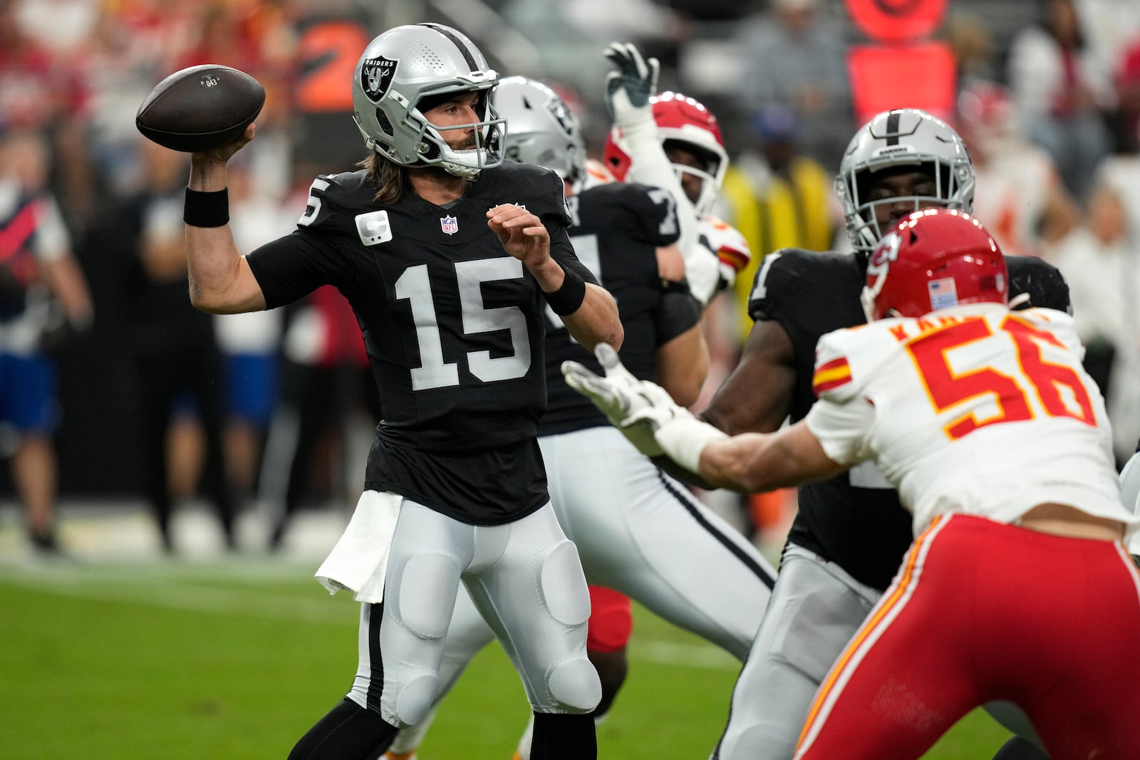 Las Vegas Raiders quarterback Gardner Minshew (15) throws during the first half of an NFL football game against the Kansas City Chiefs Sunday, Oct. 27, 2024, in Las Vegas. (AP Photo/John Locher)