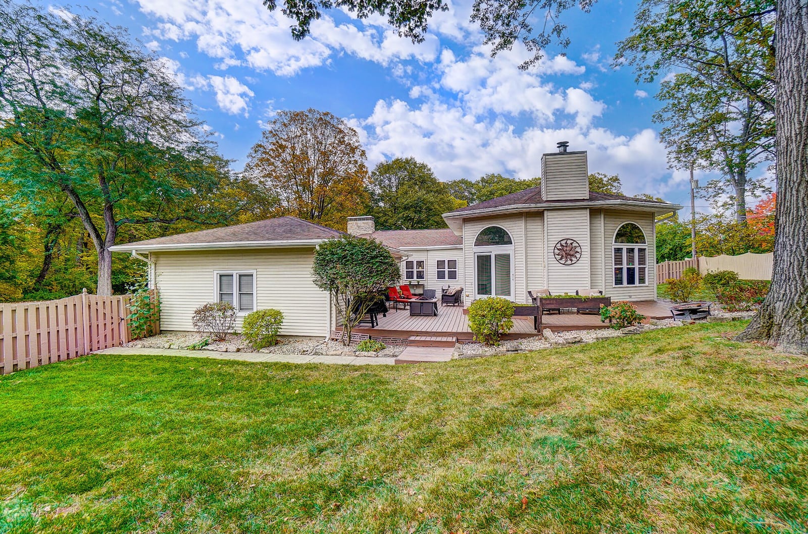 The rear of the home has a multi-level wood deck and a semiprivate sun porch. The backyard is surrounded by a privacy fence.