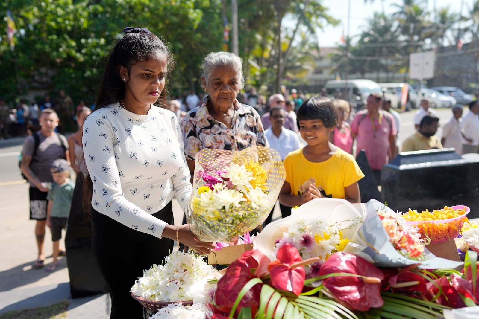 Relatives of tsunami victims offer floral tributes at a memorial built in memory of those who died during 2004 Indian Ocean tsunami as they mark the 20th anniversary in Peraliya, Sri Lanka, Thursday, Dec. 26, 2024. (AP Photo/Eranga Jayawardena)