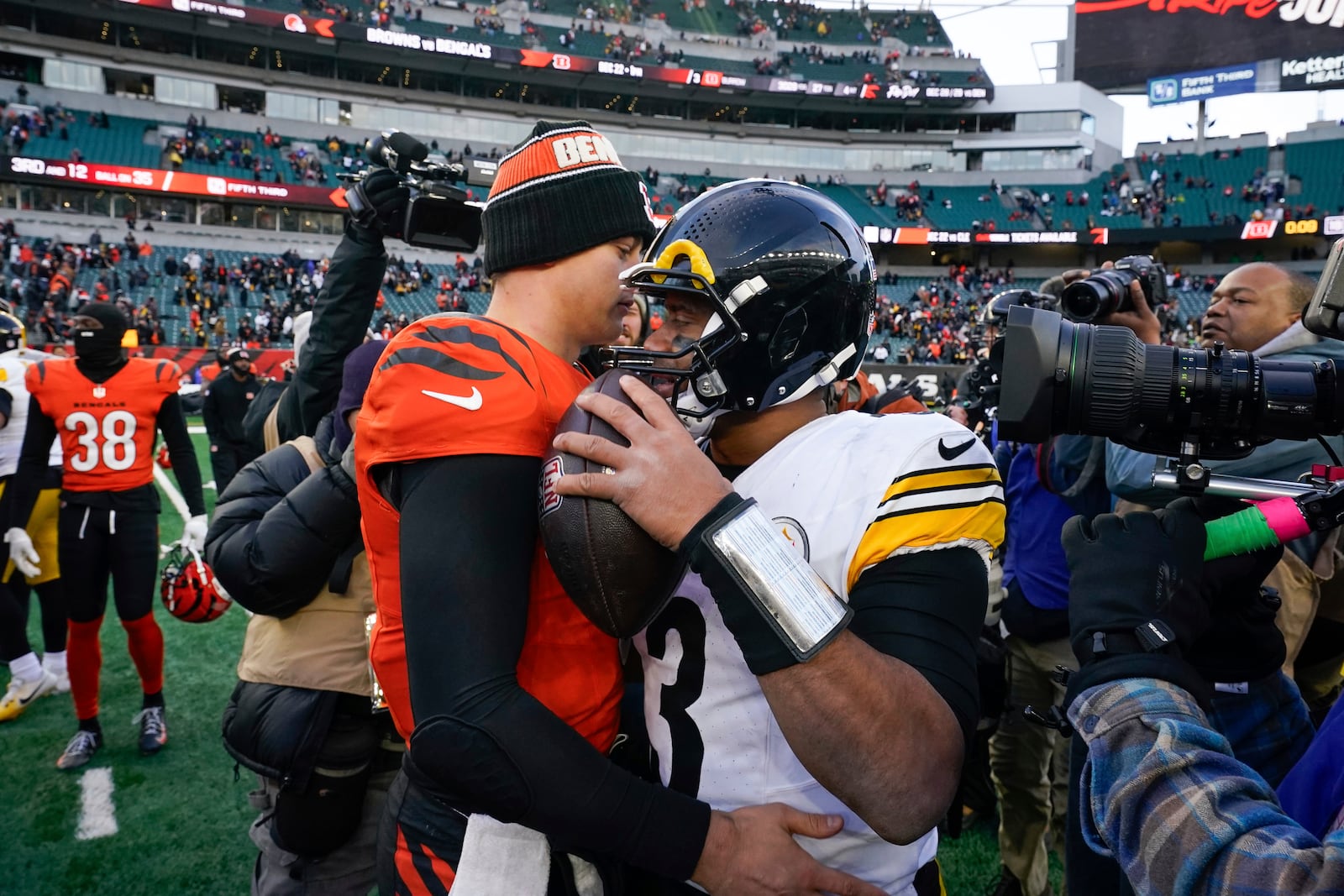 Cincinnati Bengals quarterback Joe Burrow, centerleft, speaks to Pittsburgh Steelers quarterback Russell Wilson, center right, after an NFL football game Sunday, Dec. 1, 2024, in Cincinnati. (AP Photo/Jeff Dean)