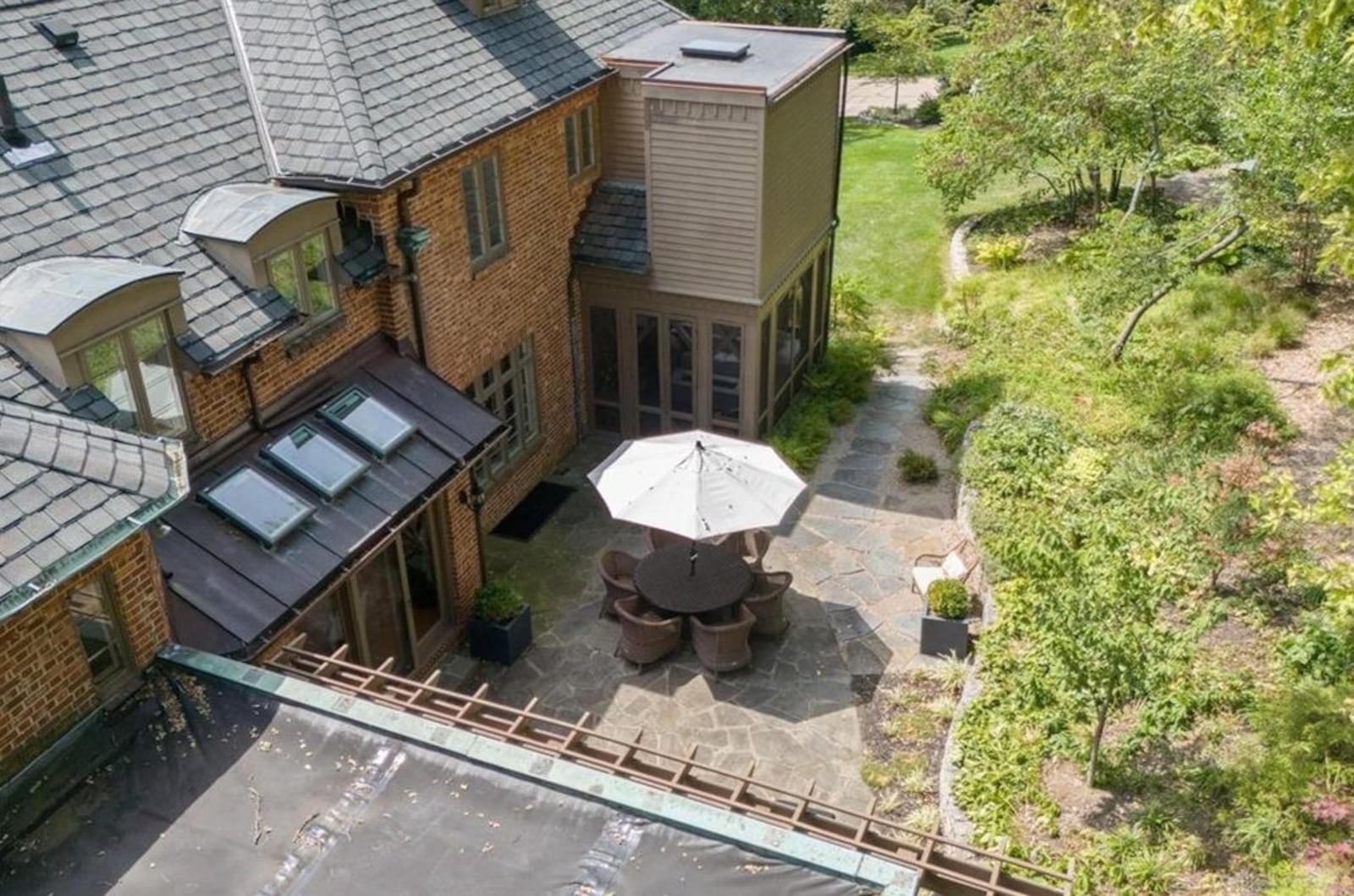 There is a stone paver patio to the rear of the home with stone retaining wall on one side.