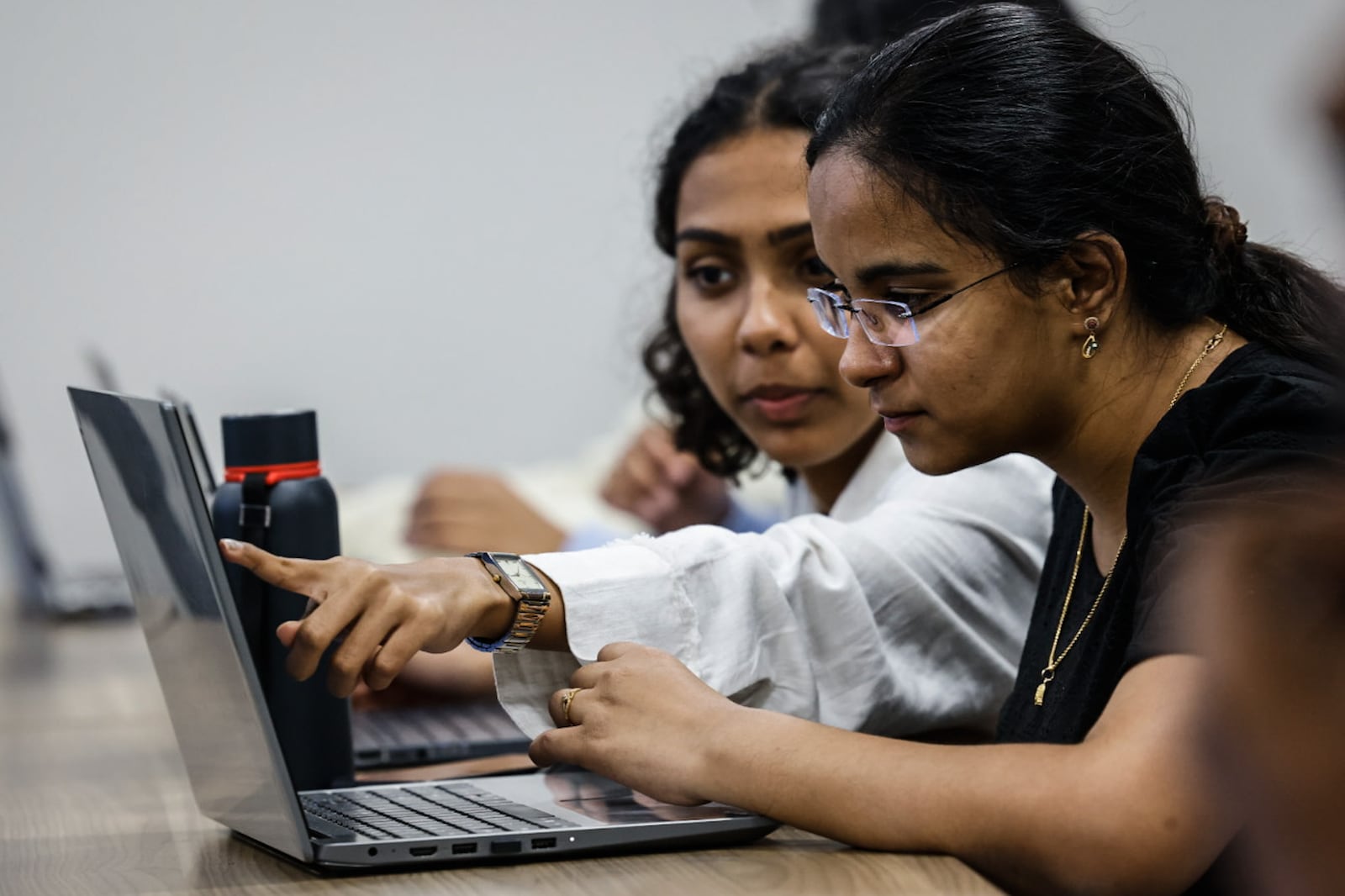 From left, Mahitha Kalaga and Anvitha Battinen, both University of Dayton juniors work on coding during class Thursday October 17, 2024. JIM NOELKER/STAFF