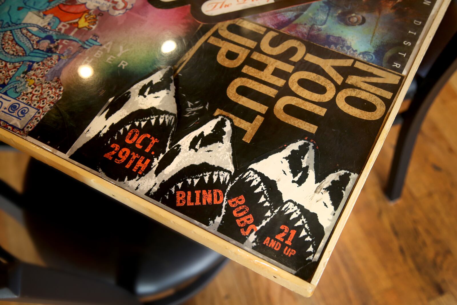 The tables at Blind Bob's in the Oregon District are covered in posters for bands. LISA POWELL / STAFF