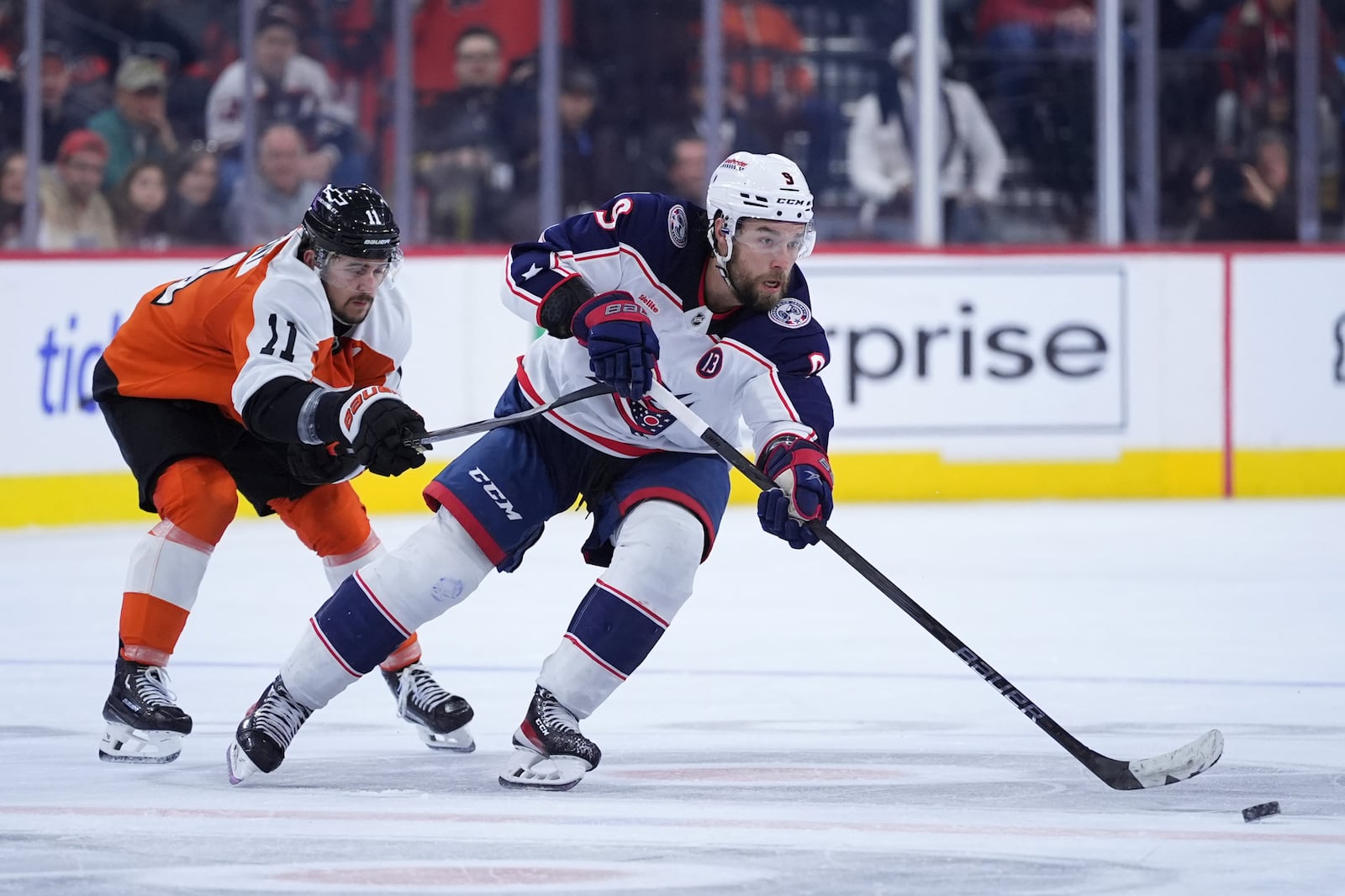 Columbus Blue Jackets' Ivan Provorov, right, tries to keep the puck away from Philadelphia Flyers' Travis Konecny during the third period of an NHL hockey game, Saturday, Dec. 21, 2024, in Philadelphia. (AP Photo/Matt Slocum)