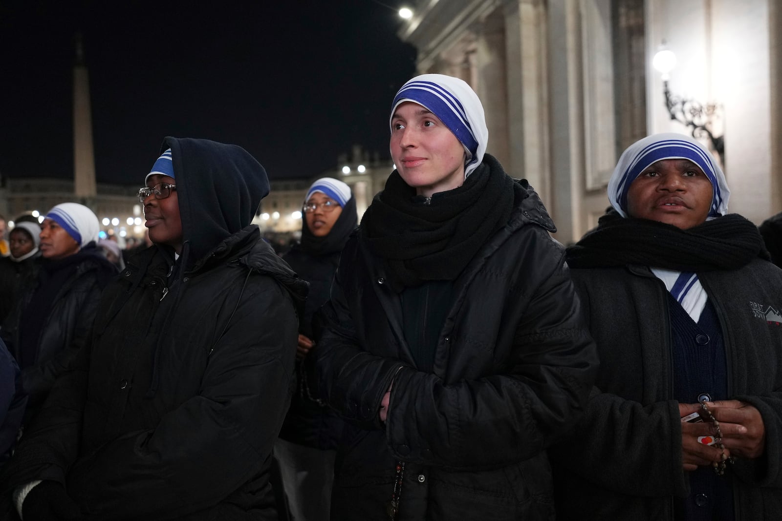 People attend as Cardinal Robert Francis Prevost, Prefect of the Dicastery for Bishops, leads the recitation of the Holy Rosary for Pope Francis' health in St Peter's Square at the Vatican, Monday, March 3, 2025. (AP Photo/Kirsty Wigglesworth)