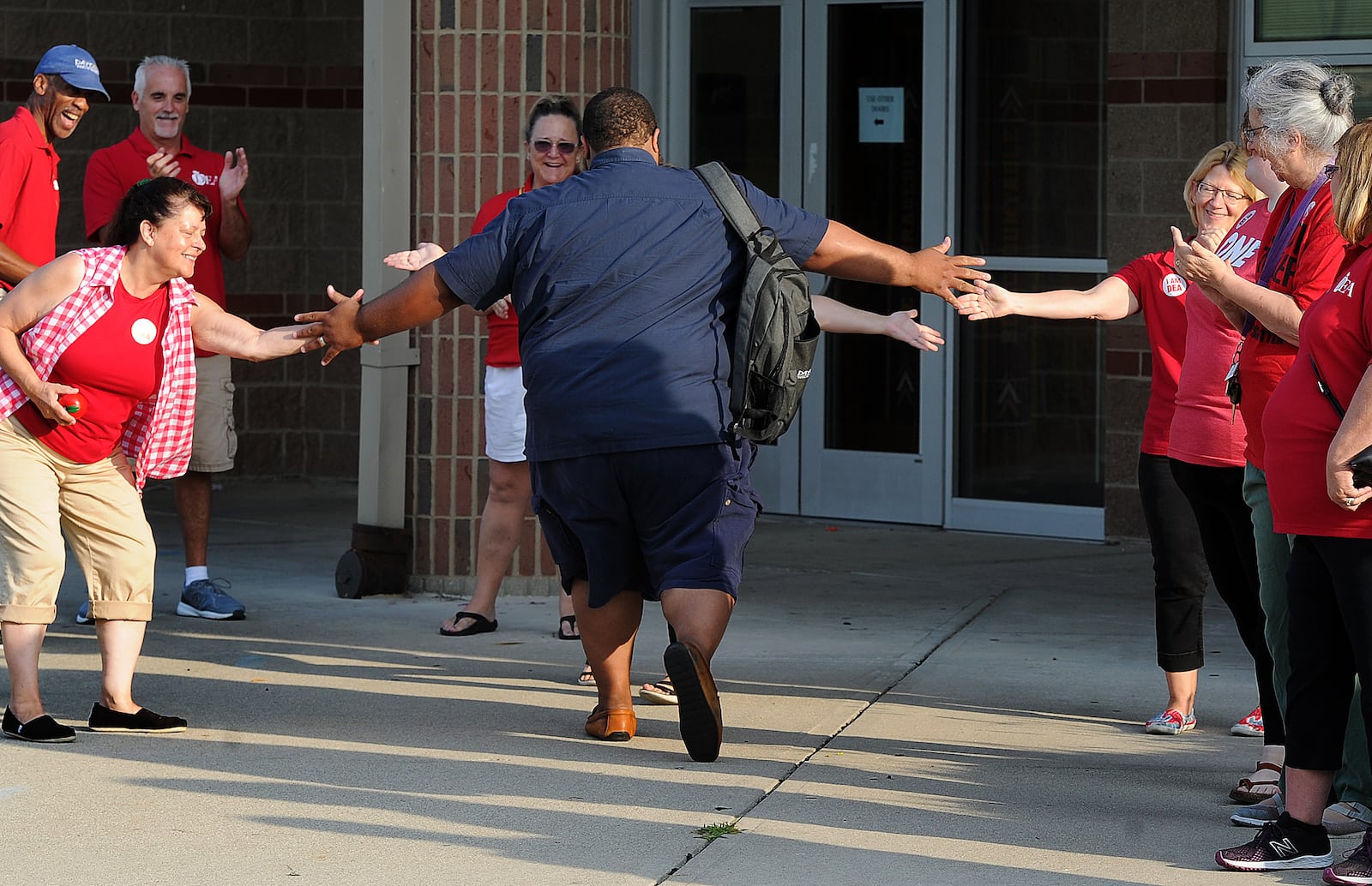 The Dayton teachers union members clap in first year teachers Thursday, Aug. 3, 2023 at Thurgood Marshall High School. MARSHALL GORBY\STAFF