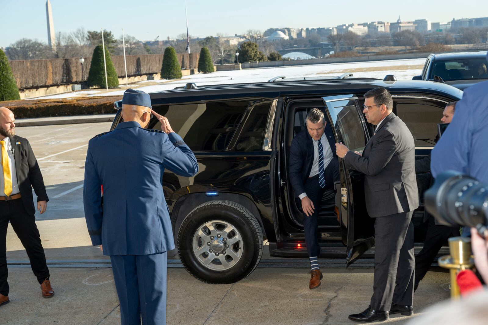 Defense Secretary Pete Hegseth, center, is saluted by Chairman of the Joint Chiefs of Staff Gen. Charles Q. Brown Jr., as he arrives at the Pentagon, Monday, Jan. 27, 2025 in Washington. (AP Photo/Kevin Wolf)