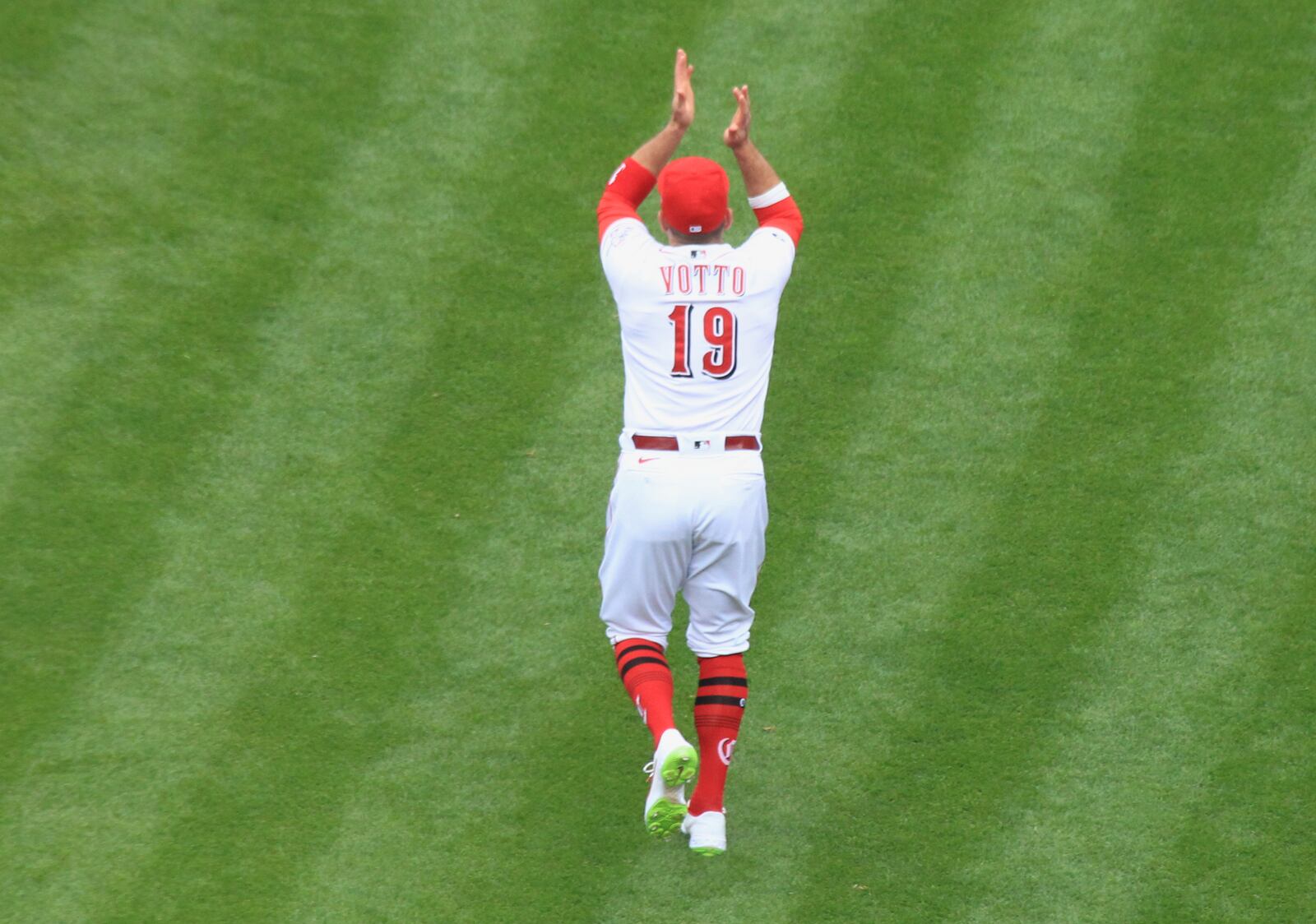 Joey Votto, of the Reds, claps after being introduced in a pregame ceremony on Opening Day on Thursday, April 1, 2021, at Great American Ball Park in Cincinnati. David Jablonski/Staff