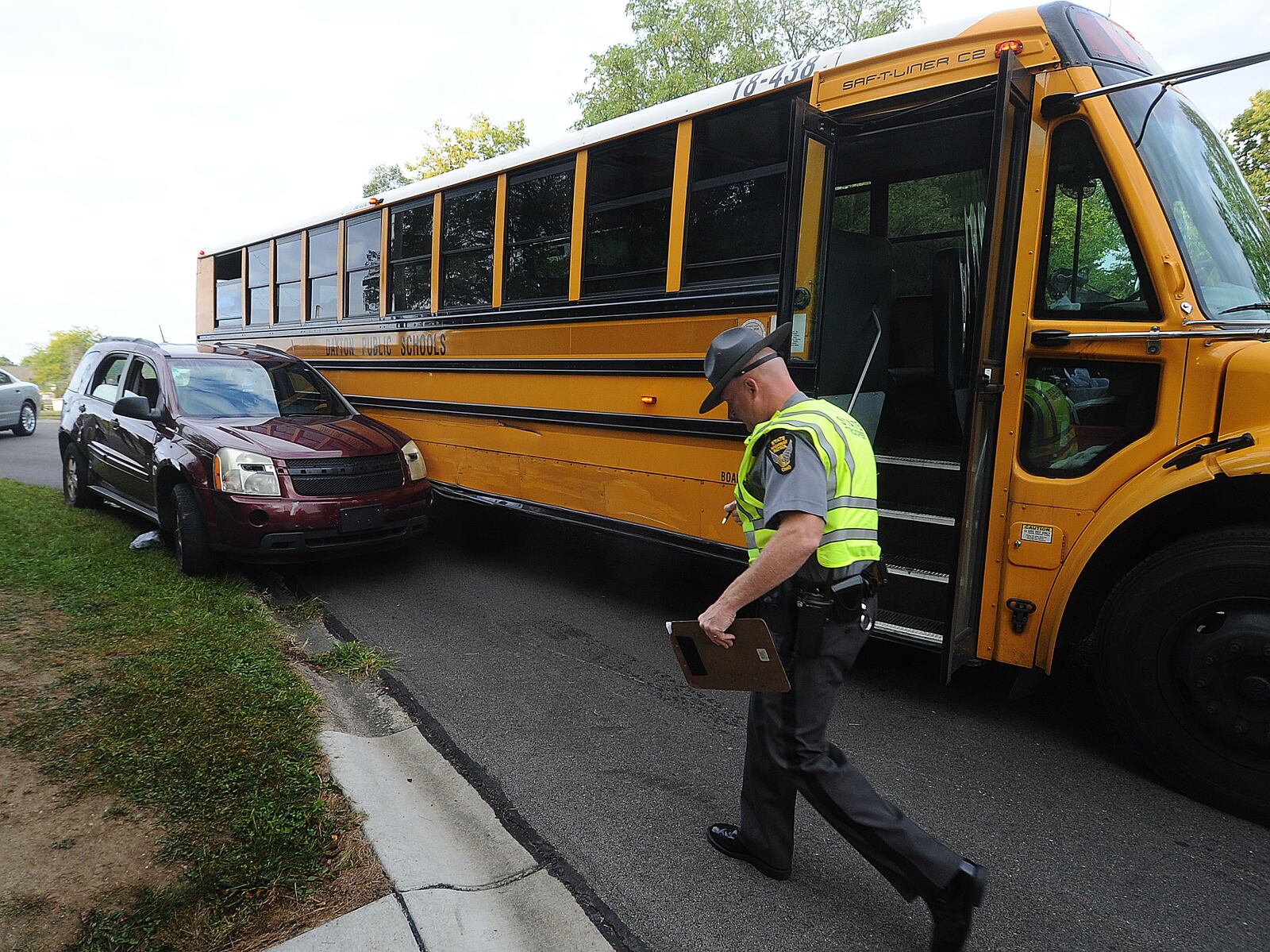 The Ohio State Highway Patrol is investigating a crash involving a Dayton Public School bus and an SUV near the Philadelphia Drive and Macy Street intersection in Harrison Twp. Tuesday, Sept. 19, 2023. One child from the bus was transported by medics. MARSHALL GORBY\STAFF