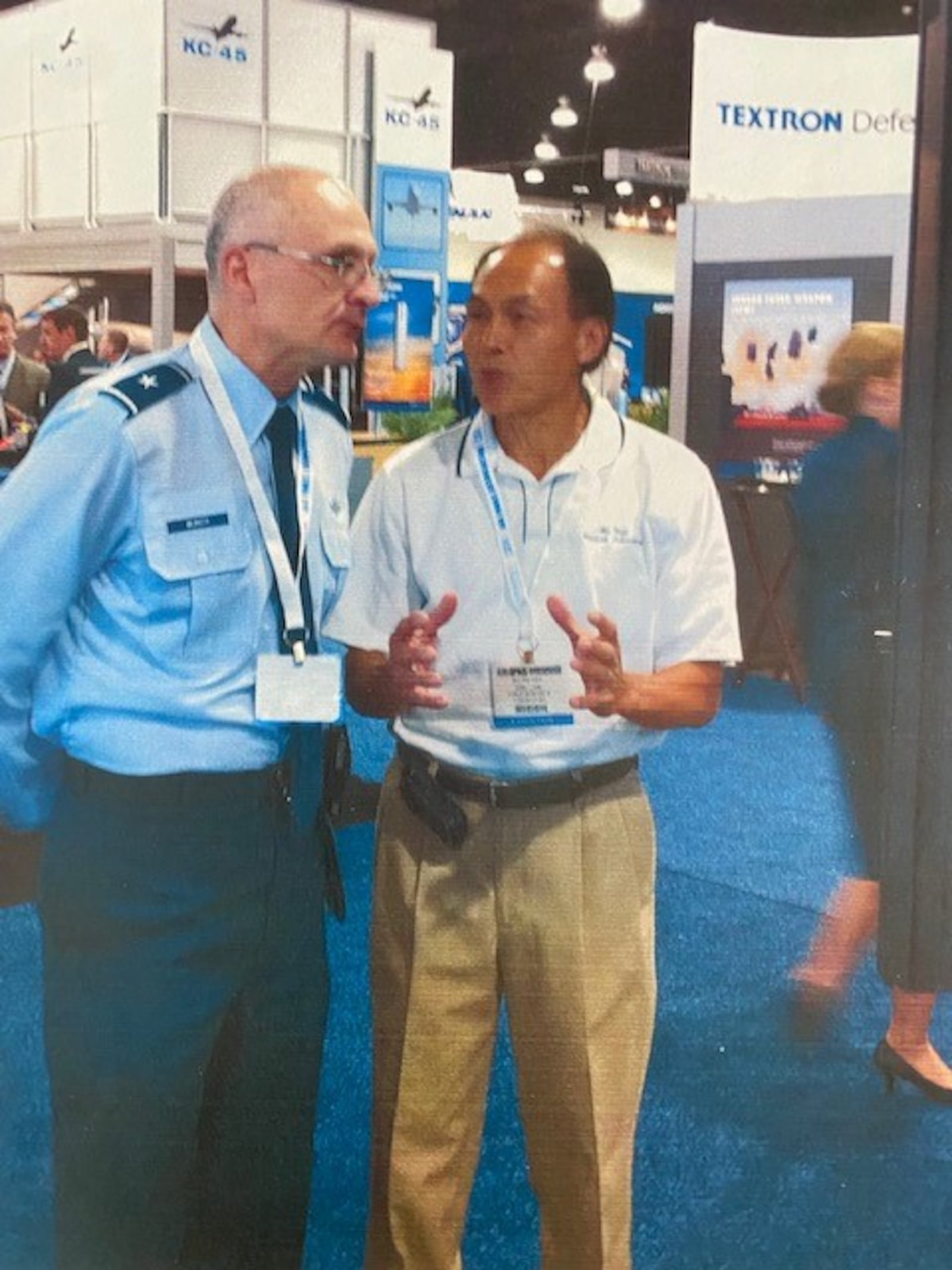 Ba Nguyen (right) a research engineer at the Air Force Research Laboratory at Wright Patterson AFB, explains his work to a one star general at an air refueling show.  CONTRIBUTED