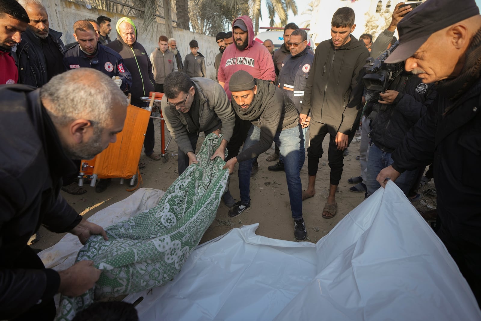 Bodies of victims of an Israeli strike on a home in Deir al-Balah late Saturday are prepared for the funeral outside the Al-Aqsa Martyrs Hospital in Deir al-Balah Sunday, Dec. 22, 2024. At least eight people were killed according to the hospital which received the bodies.(AP Photo/Abdel Kareem Hana)