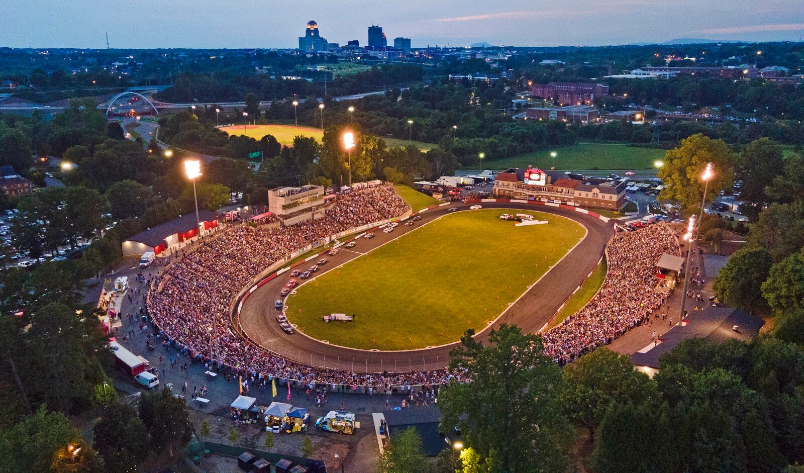 FILE - An aerial view of Bowman Gray Stadium and the Winston-Salem, N.C. skyline during the season finale auto race, Saturday, Aug. 20, 2022. (Walt Unks/The Winston-Salem Journal via AP, File)