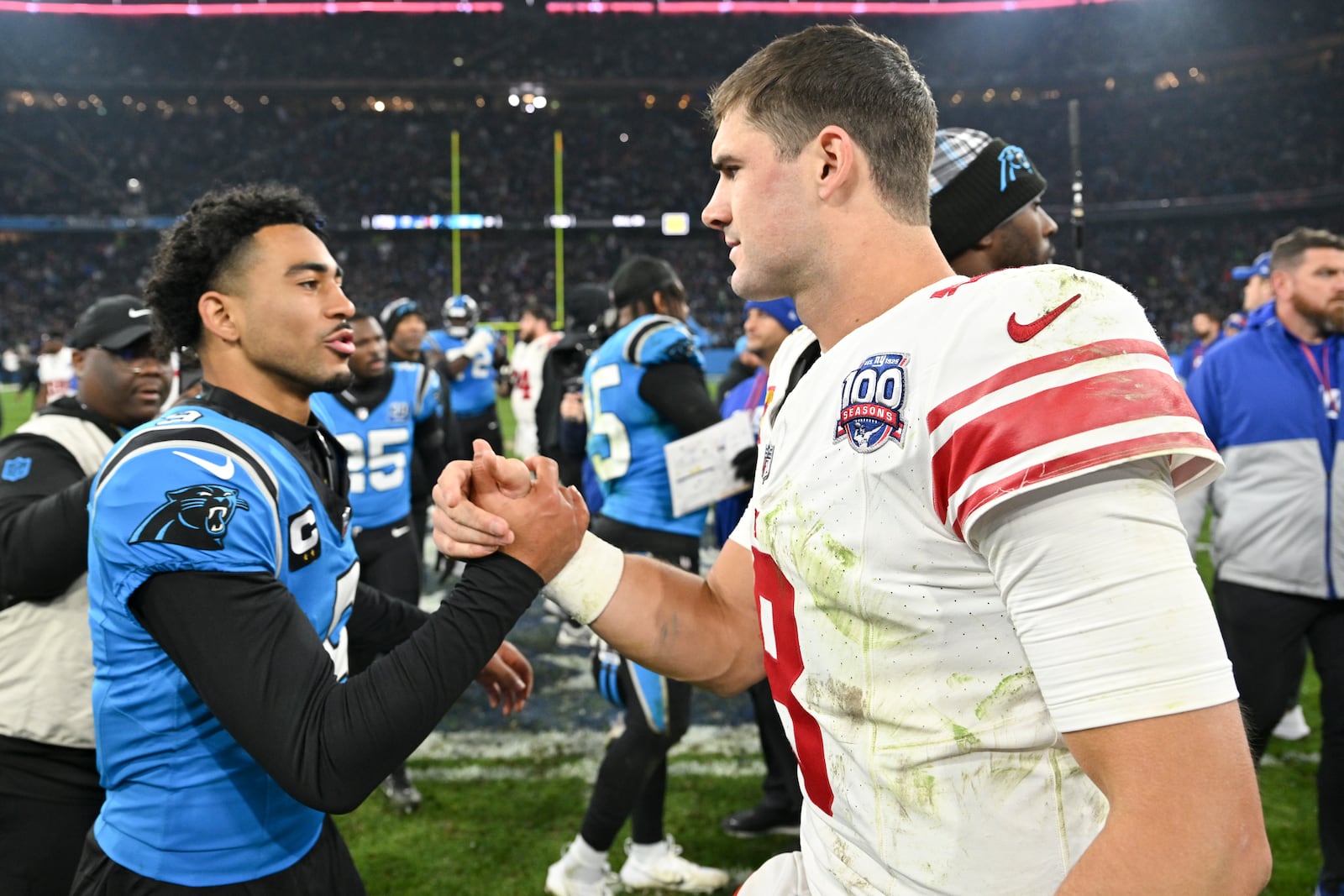 Carolina Panthers quarterback Bryce Young greets New York Giants quarterback Daniel Jones after their overtime win in an NFL football game, Sunday, Nov. 10, 2024, in Munich, Germany. (AP Photo/Lennart Preiss)