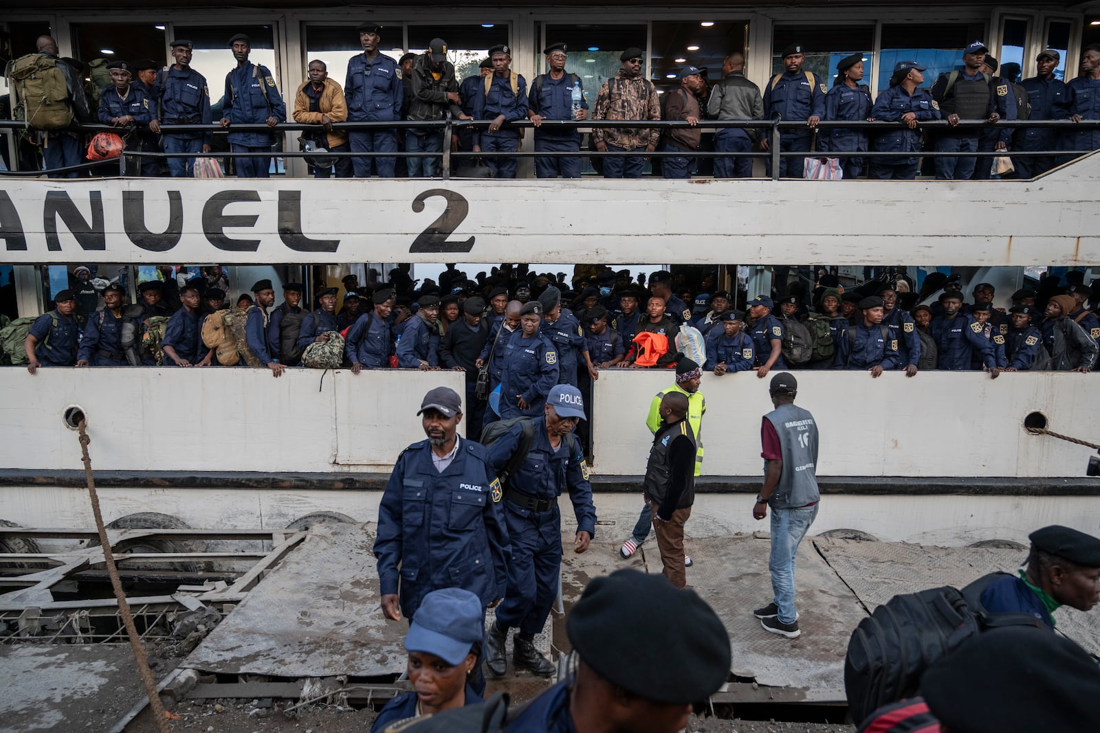 Former members of the Armed Forces of the Democratic Republic of Congo (FARDC) and police officers who allegedly surrendered to M23 rebels arrive in Goma, Congo, Sunday, Feb. 23, 2025. (AP Photo/Moses Sawasawa)