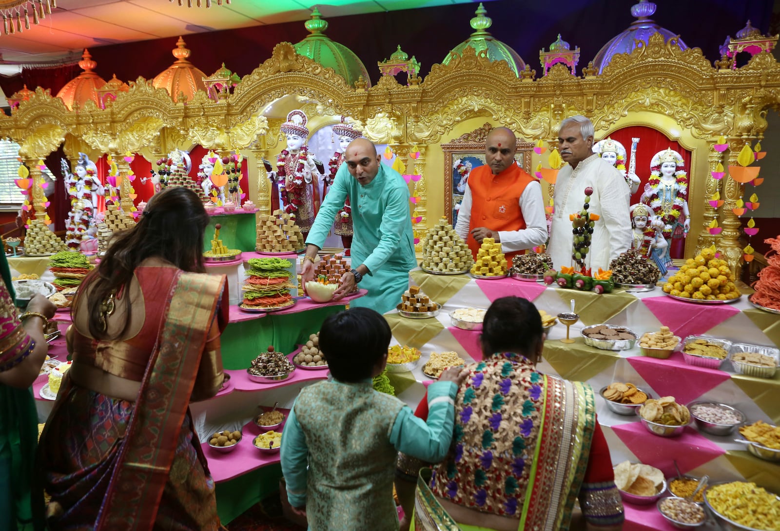 FILE - Offerings of vegetarian foods and sweets are brought to the gods at BAPS Shri Swaminarayan Temple for the Hindu New Year, Oct. 28, 2019, in Salem, during Prasada, the culmination of the five-day Diwali celebrations. (Heather Rousseau/The Roanoke Times via AP, File)