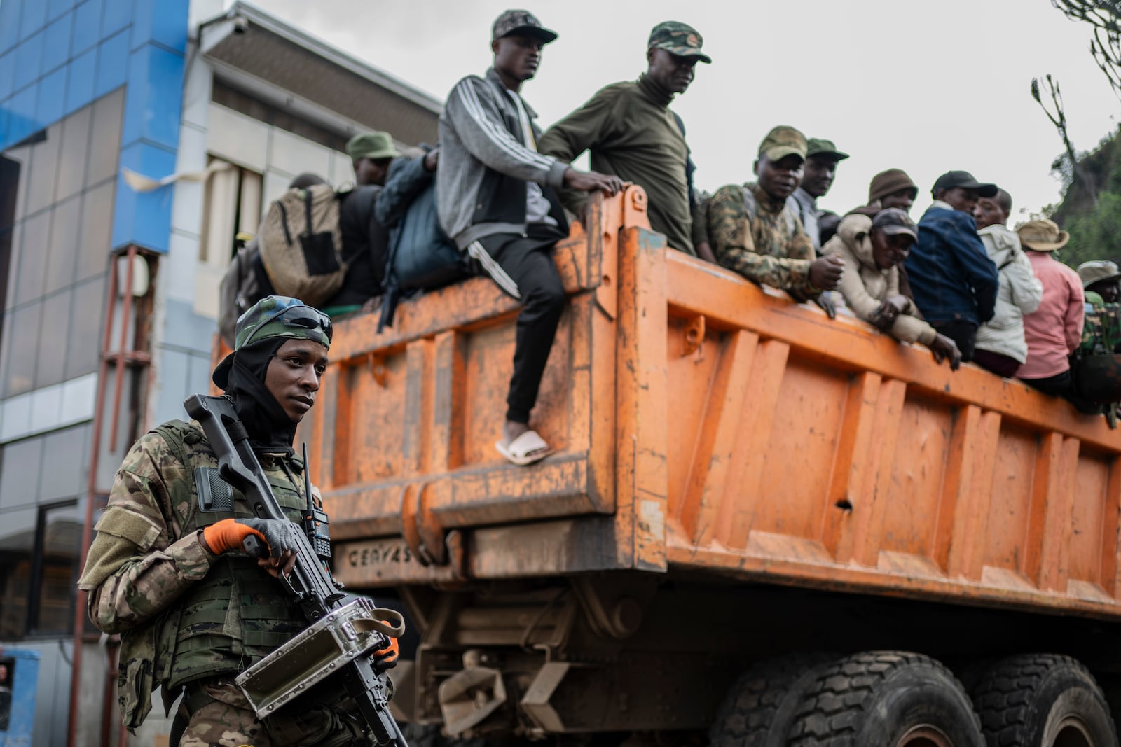 Former members of the Armed Forces of the Democratic Republic of Congo (FARDC) and police officers who allegedly surrendered to M23 rebels arrive in Goma, Congo, Sunday, Feb. 23, 2025. (AP Photo/Moses Sawasawa)