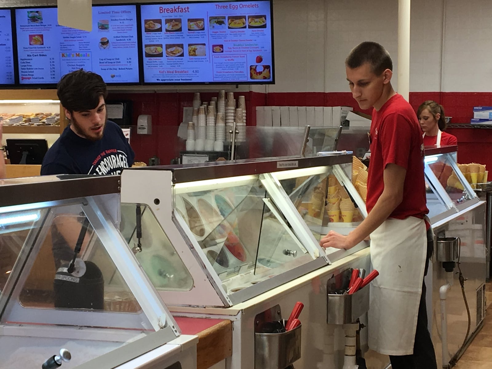 Young’s Jersey Dairy employee helps a customer ordering ice cream. KARA DRISCOLL/STAFF