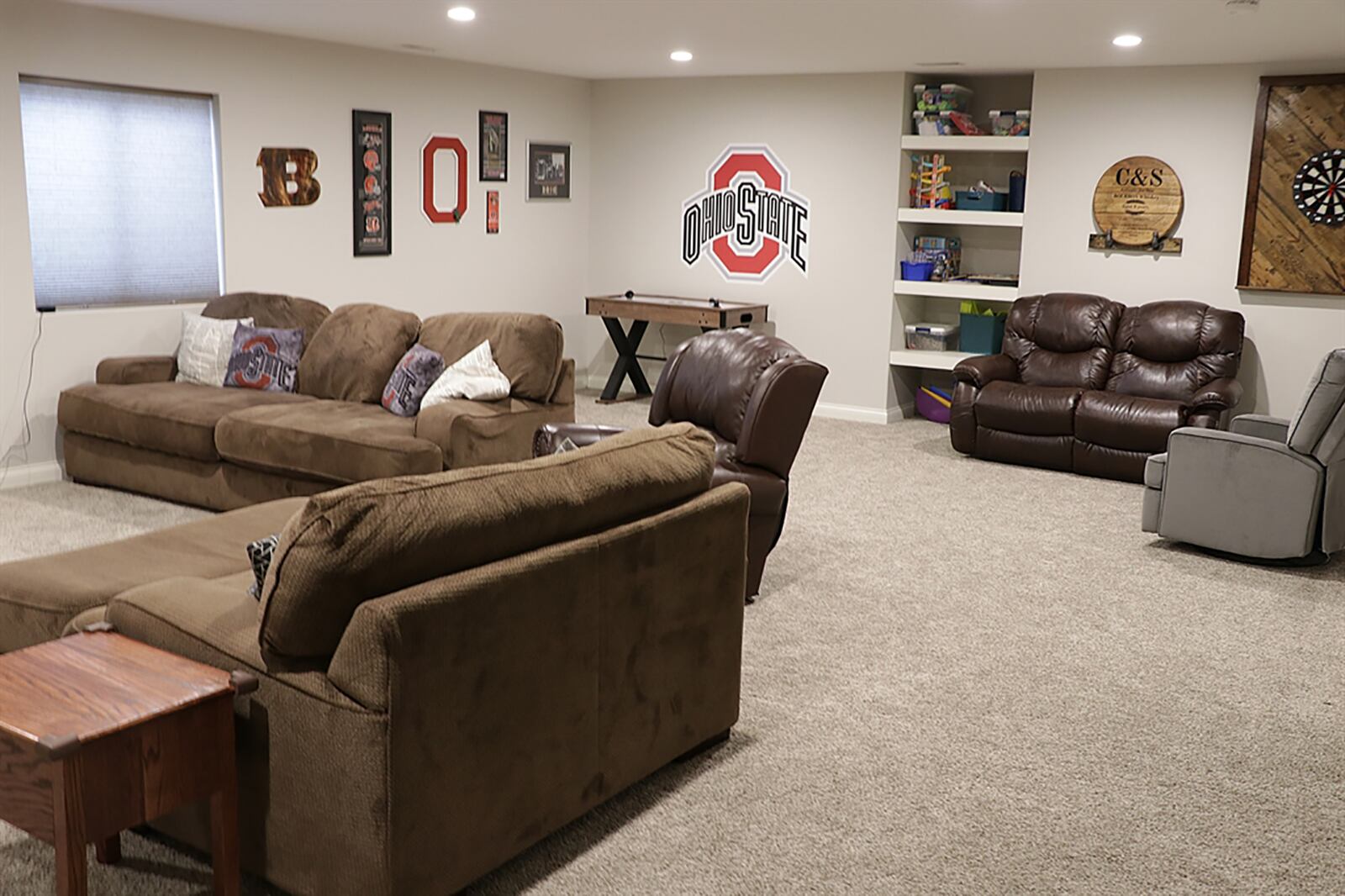 The lower level has been finished into a recreation family room with a large egress window and a built-in bookcase. Tucked back off the family room is a door that opens into a fourth bedroom suite. CONTRIBUTED PHOTO BY KATHY TYLER