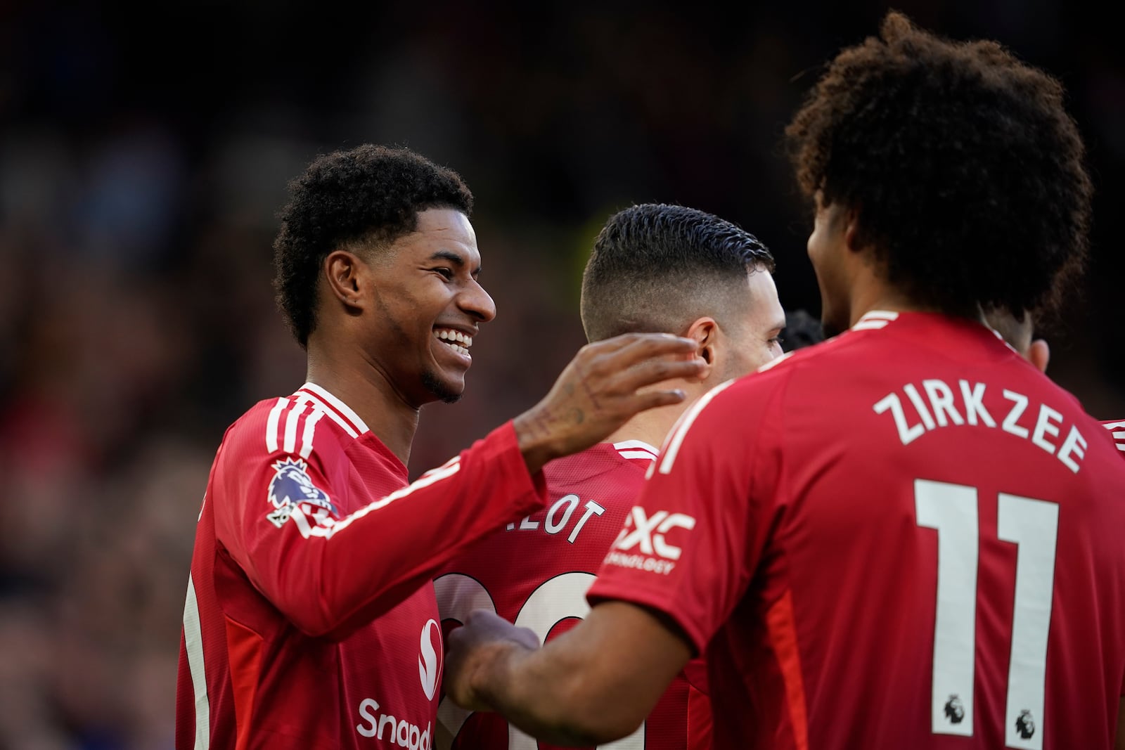 Manchester United's Marcus Rashford, left, celebrates with teammates after scoring during the English Premier League soccer match between Manchester United and Everton at the Old Trafford stadium in Manchester, England, Sunday, Dec. 1, 2024. (AP Photo/Dave Thompson)