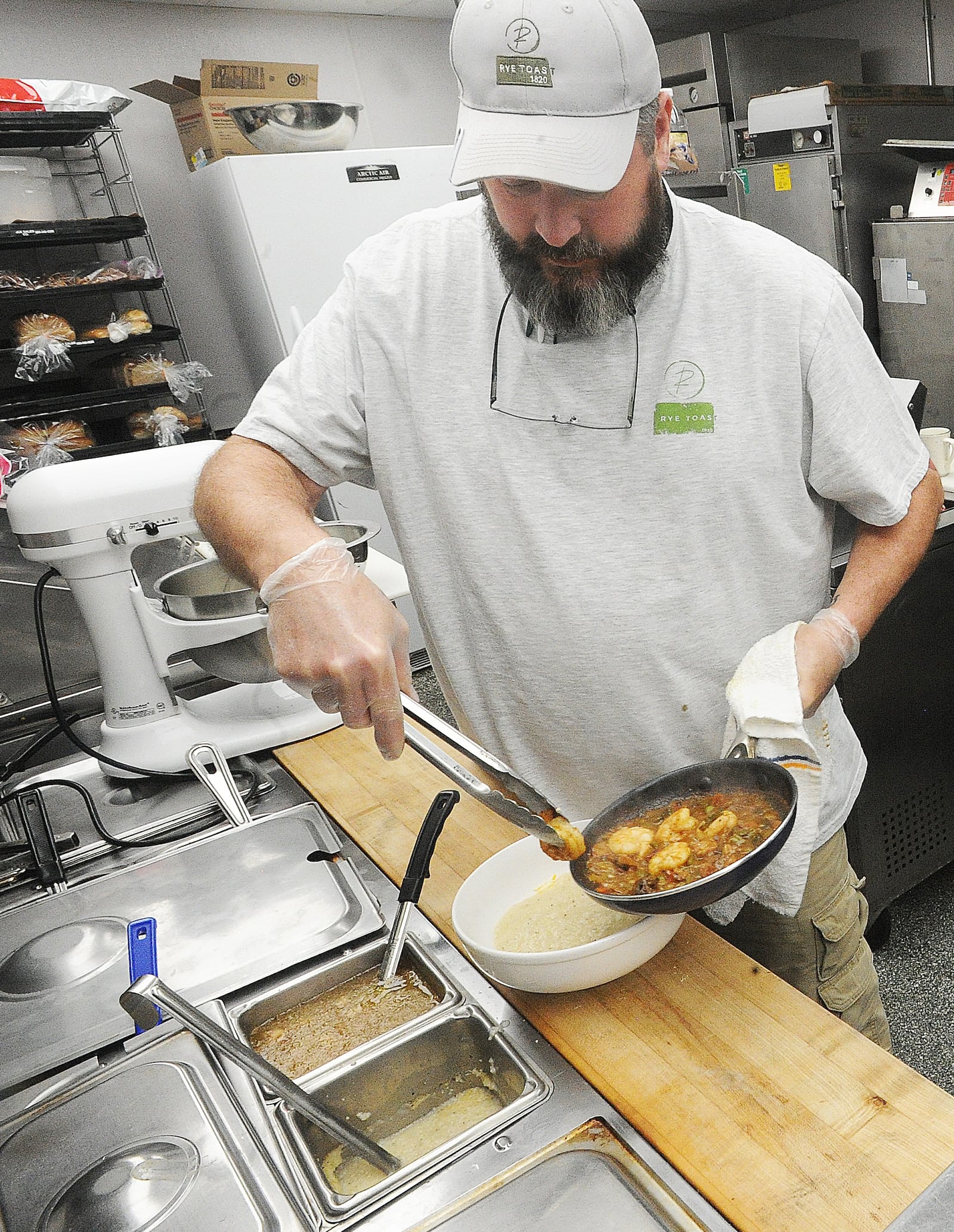 Chef Tom Tiner, owner of the Rye Toast Diner in Miamisburg, prepares one of his favorite dishes, Shrimp & Grits.  MARSHALL GORBY\STAFF