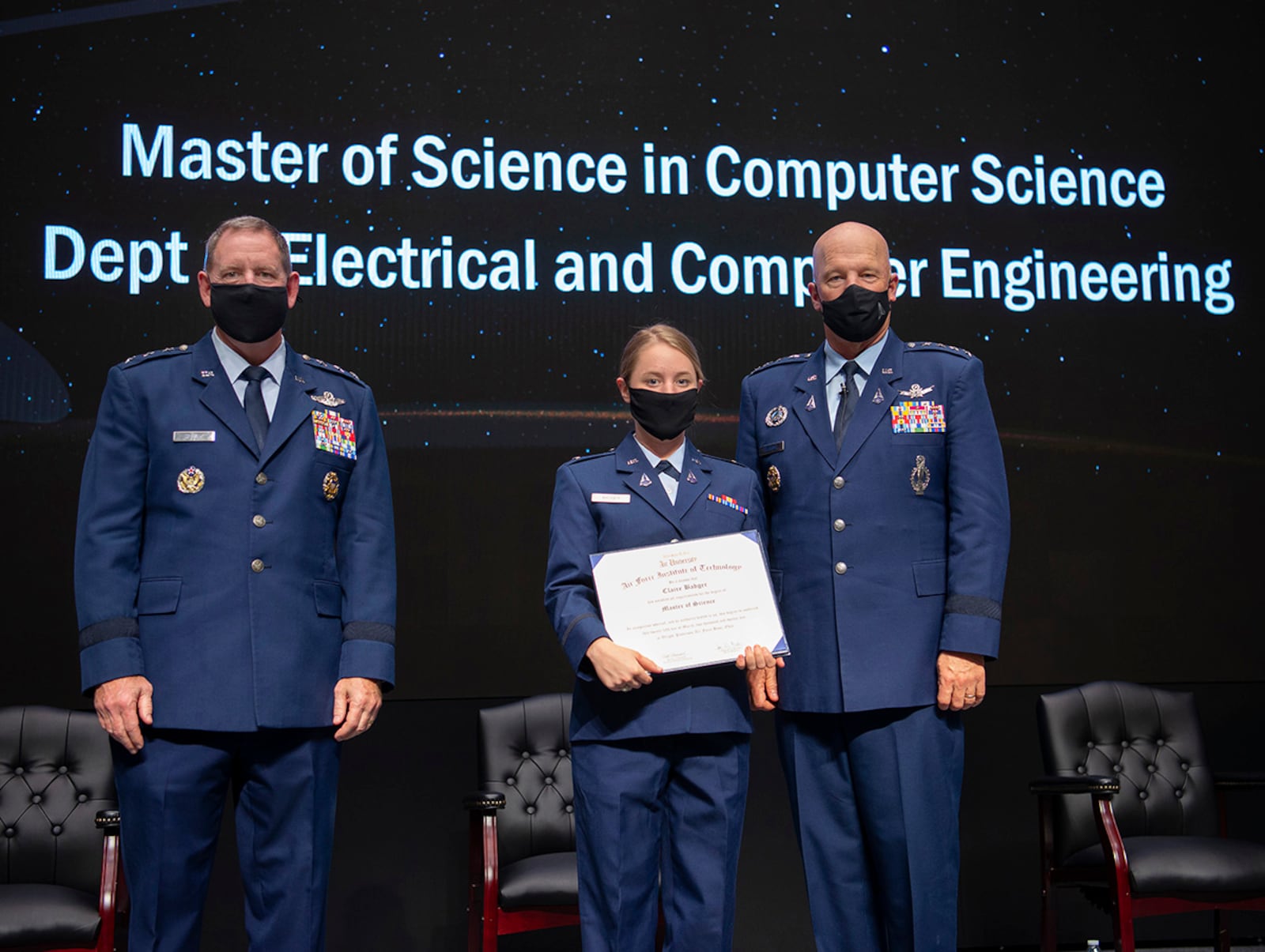 Gen. John W. “Jay” Raymond (right), chief of Space Operations, and Lt. Gen. James Hecker (left), Air University commander and president, present Space Force 2nd Lt. Claire Badger with her Master of Science degree during the Air Force Institute of Technology graduation ceremony March 25 at Wright-Patterson Air Force Base. The graduating class of more than 230 students included 34 Guardians earning advanced degrees. U.S. AIR FORCE PHOTO/R.J. ORIEZ