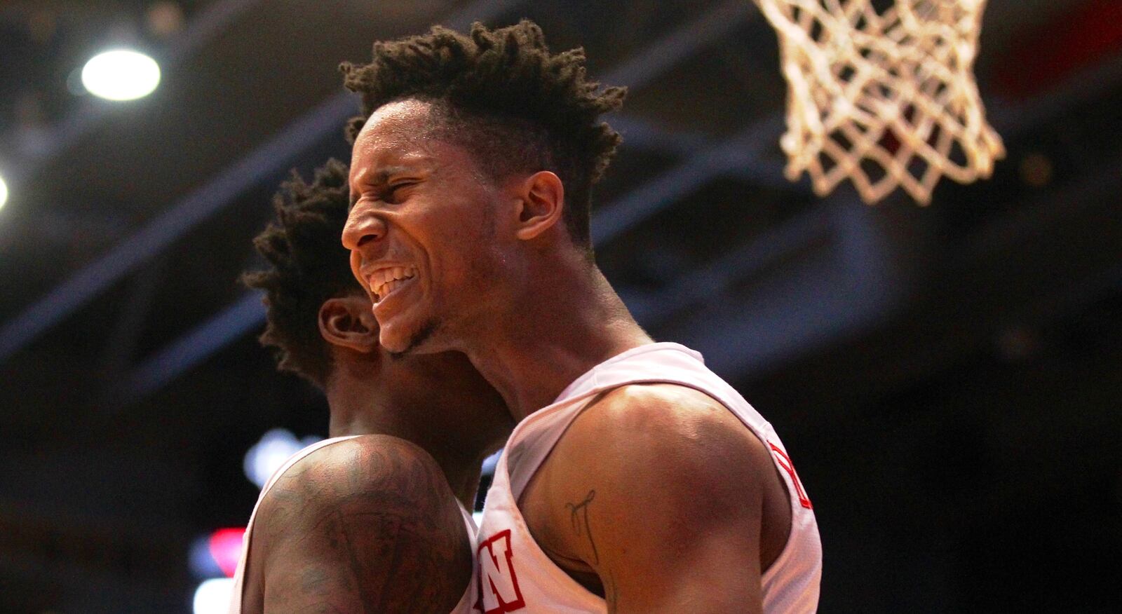 Darrell Davis, right, bumps chests with John Crosby after making a shot against Ball State on Friday, Nov. 10, 2017, at UD Arena. David Jablonski/Staff