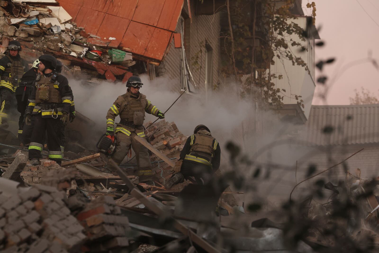 Rescue workers clear the rubble of a residential building destroyed by a Russian airstrike in Zaporizhzhia, Ukraine, Thursday, Nov. 7, 2024. (AP Photo/Kateryna Klochko)