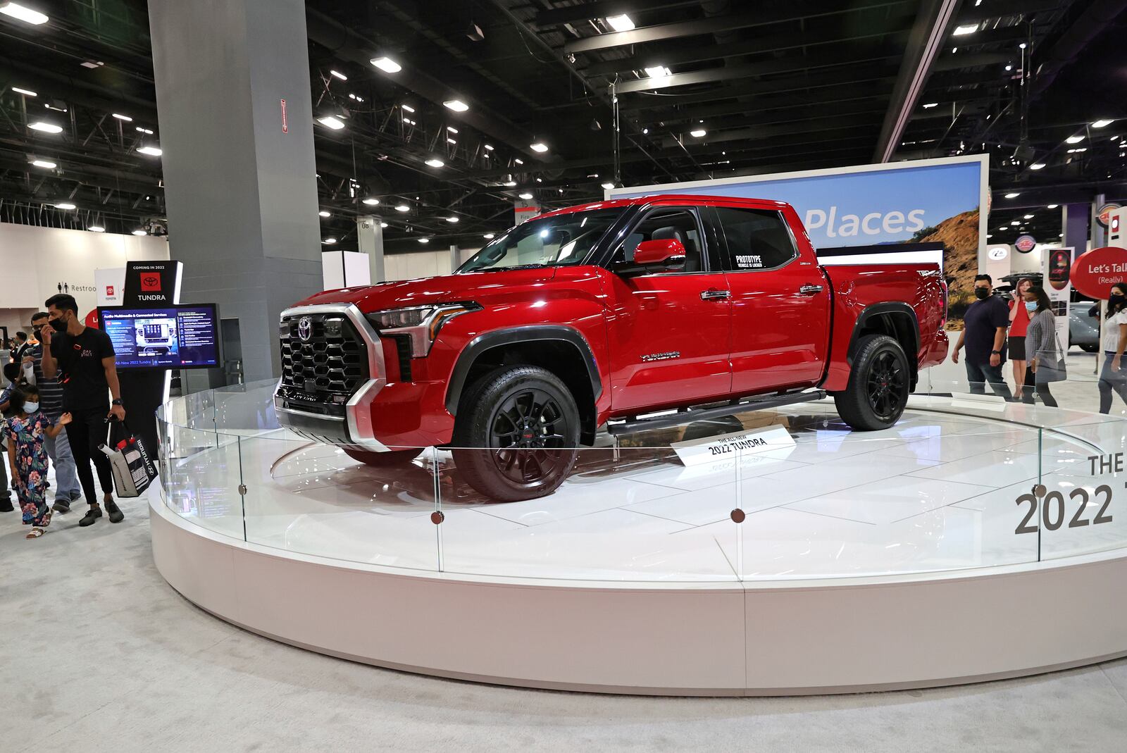 Car enthusiasts walk by the Toyota Tundra 2022 is seen at the Miami International Auto Show in the Miami Beach Convention Center on Sunday, Oct. 17, 2021 in Miami Beach, Fla. (David Santiago/Miami Herald via AP)