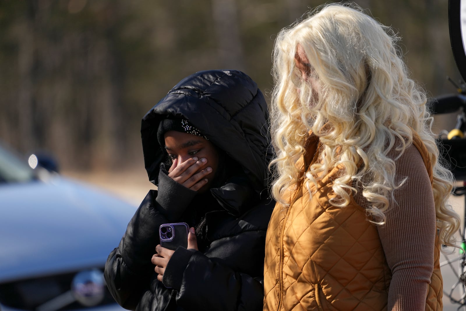 Antioch High School student Jaliana Baskin, left, visits a memorial for victims of a shooting at the school with her mother Madonna Elmore, right, Thursday, Jan. 23, 2025, in Nashville, Tenn. (AP Photo/George Walker IV)