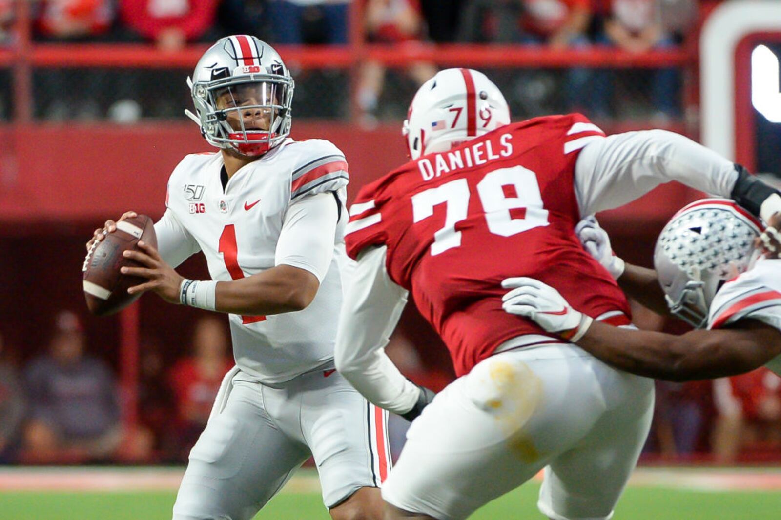 LINCOLN, NE - SEPTEMBER 28: Quarterback Justin Fields #1 of the Ohio State Buckeyes passes ahead of the rush from defensive lineman Darrion Daniels #79 of the Nebraska Cornhuskers at Memorial Stadium on September 28, 2019 in Lincoln, Nebraska. (Photo by Steven Branscombe/Getty Images)