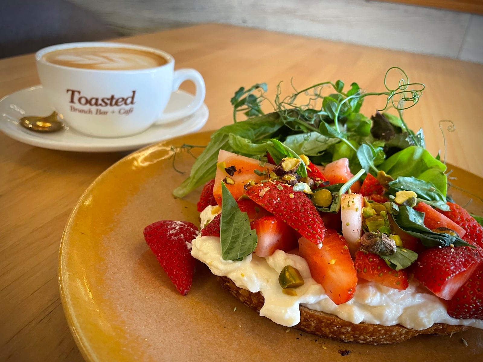 Toasted Brunch Bar + Cafe, a new restaurant concept specializing in traditional American and internationally fused breakfast, lunch and dinner options, is opening Friday, Nov. 8 just outside of the Mall at Fairfield Commons in Beavercreek. Pictured is the Strawberry + Basil Toast. NATALIE JONES/STAFF