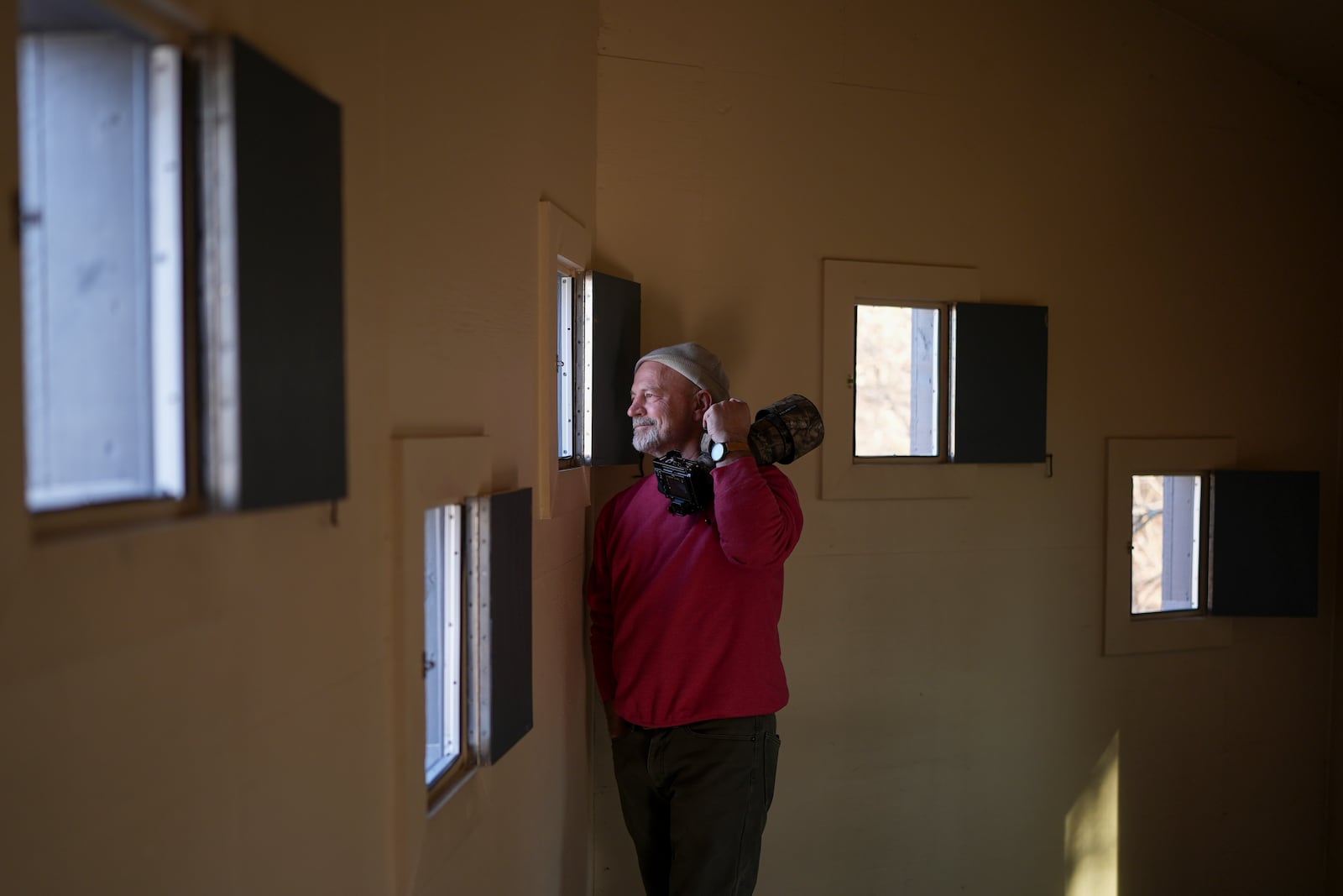 Joel Giles looks out from a photography blind as he photographs sandhill cranes at the Wheeler National Wildlife Refuge, Monday, Jan. 13, 2025, in Decatur, Ala. (AP Photo/George Walker IV)