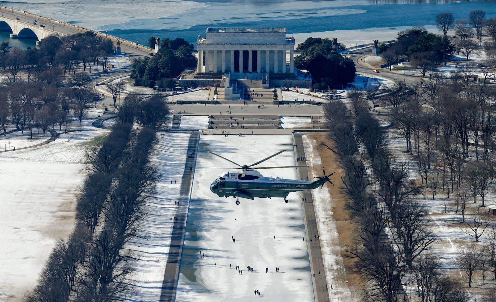 A Marine helicopter carrying former President Joe Biden and Jill Biden, flies past the Lincoln Memorial, rear, after lifting from the U.S. Capitol en route to Joint Base Andrews, after the Biden's attended the 60th Presidential Inauguration in the Rotunda of the U.S. Capitol in Washington, Monday, Jan. 20, 2025. (Brendan McDermid/Pool photo via AP)