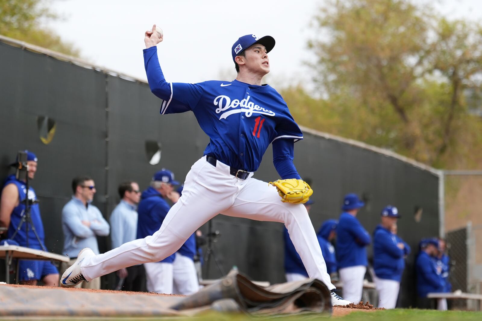 FILE - Los Angeles Dodgers pitcher Roki Sasaki, of Japan, throws during a pitching session at the team's baseball spring training facility in Phoenix, Feb. 12, 2025. (AP Photo/Ross D. Franklin, File)