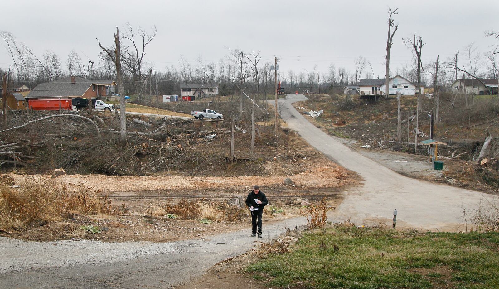 Aaron Krueger could barely see neighbors’ homes from his on Murwood Court in Beavercreek before the Memorial Day tornadoes swept through heavily wooded Grange View Acres. Now some of the homes are gone and others are in plain view. CHRIS STEWART / STAFF