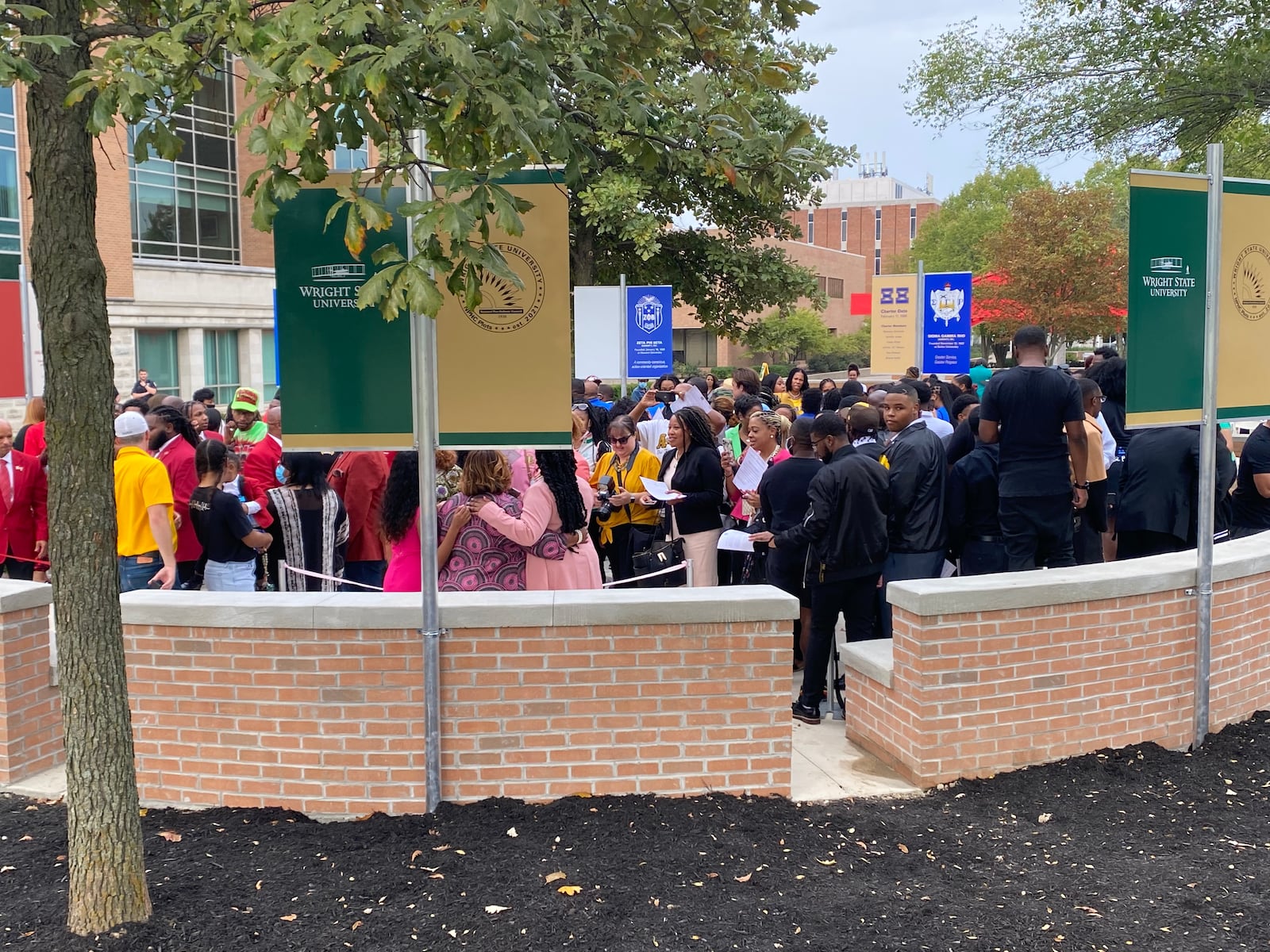 NPHC members walk into the National Pan-Hellenic Council Memorial Plots for the first time after the ribbon cutting on Saturday. Eileen McClory / Staff