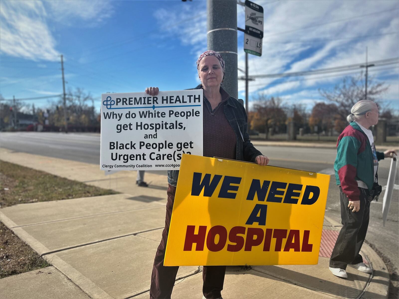 Nancy Kiehl, a member of the Clergy Coalition Community, protests outside of a ceremonial groundbreaking event on Friday, Oct. 28, 2022, for a new facility on the former Good Samaritan Hospital site. CORNELIUS FROLIK / STAFF