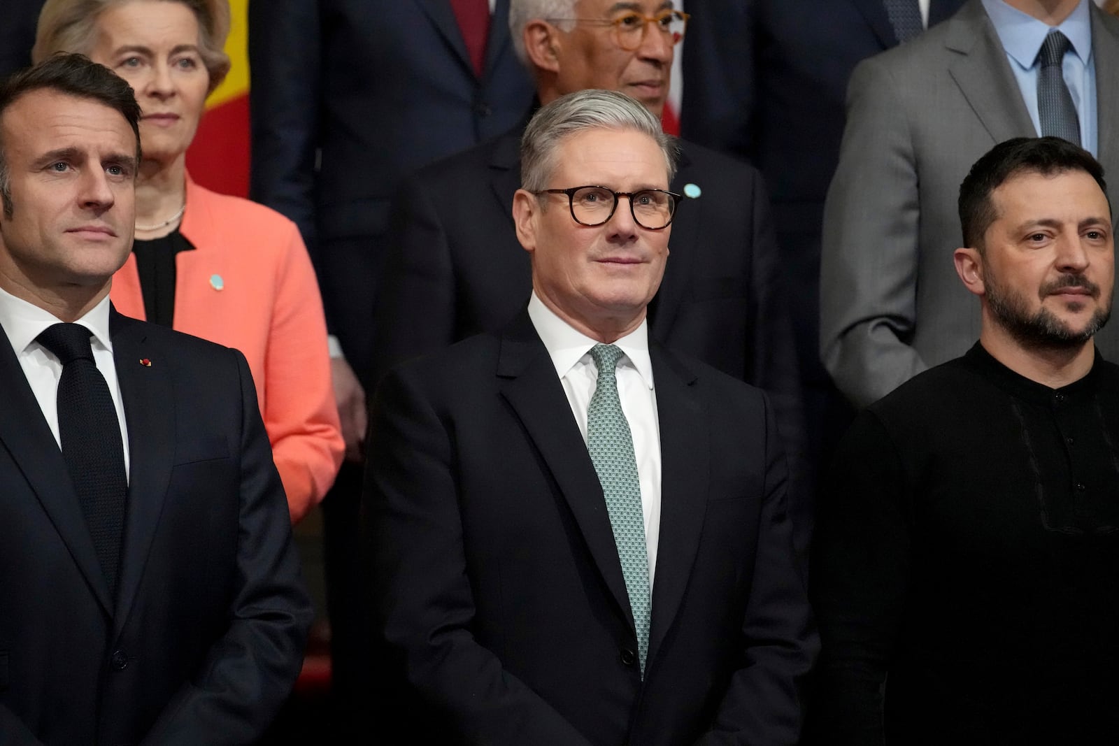 From left, French President Emmanuel Macron, Britain's Prime Minister Keir Starmer and Ukraine's President Volodymyr Zelenskyy pose during a group photo at a summit on Ukraine at Lancaster House in London, Sunday, March 2, 2025. (AP Photo/Christophe Ena, Pool)