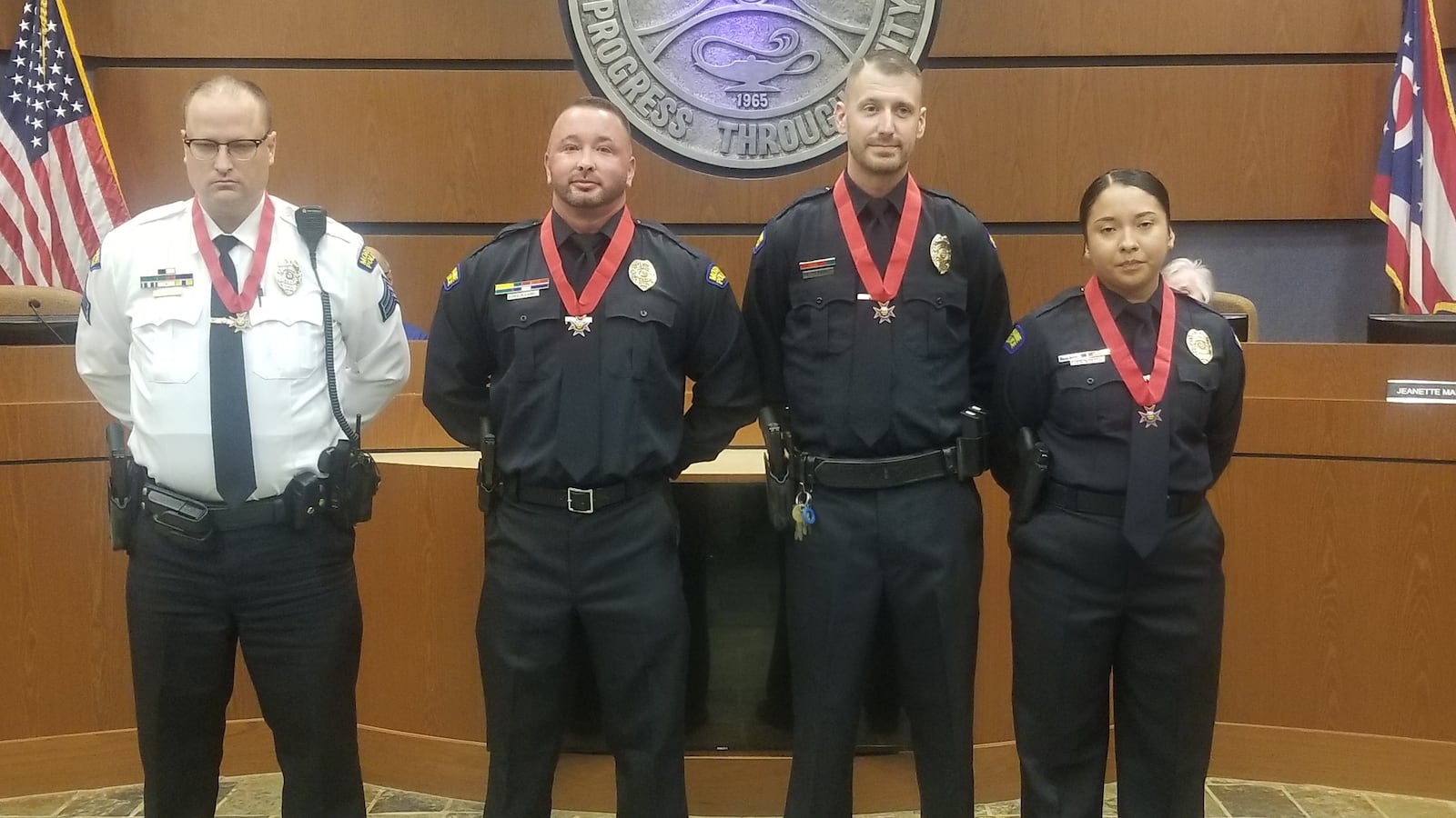 Moraine Police Chief Craig Richardson presented the Moraine Police Division's Medal of Valor to (left to right) Sgt. Ken Lloyd and officers Paul Land, Tyler Dennis and Karen Arriaga-Perez on Thursday, Oct. 26, 2023, "for their deliberate acts of heroism" while responding to a shooting at DMAX, 3100 Dryden Road, the night of May 18, 2023. CONTRIBUTED