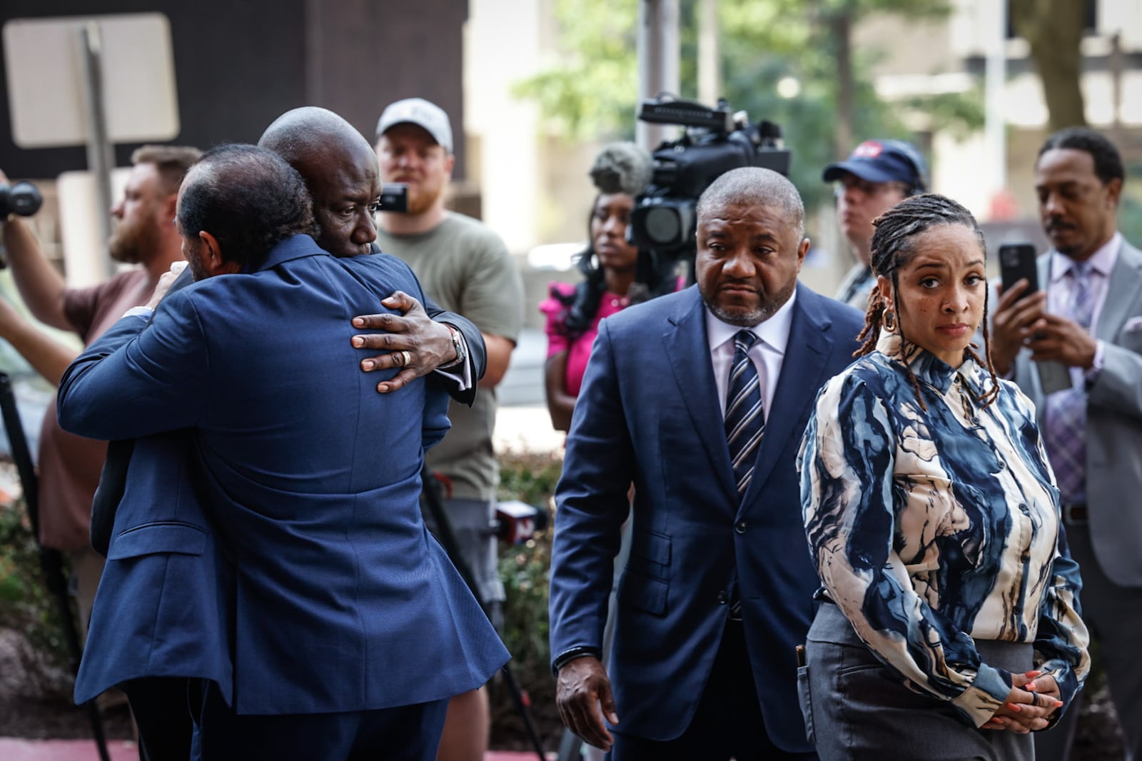 Civil rights attorney Benjamin Crump, left, hugs Skip Ross, the father of Colby Ross, following a news conference Wednesday, July 31, 2024, in downtown Dayton. Colby Ross died after being struck by a driver being chased by Montgomery County Sheriff's Office deputies in May. At right is Dayton attorney Michael Wright and Chenea Ross, the widow of Colby Ross. JIM NOELKER/STAFF