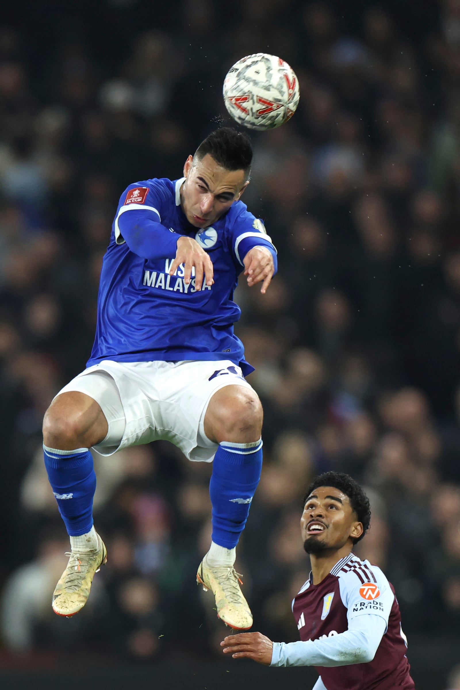 Cardiff City's Anwar Ei Ghazi, top, and Aston Villa's Ian Maatsen challenge for the ball during the English FA Cup fifth round soccer match between Aston Villa and Cardiff City at the Villa Park stadium in Birmingham, England, Friday, Feb. 28, 2025. (AP Photo/Darren Staples)