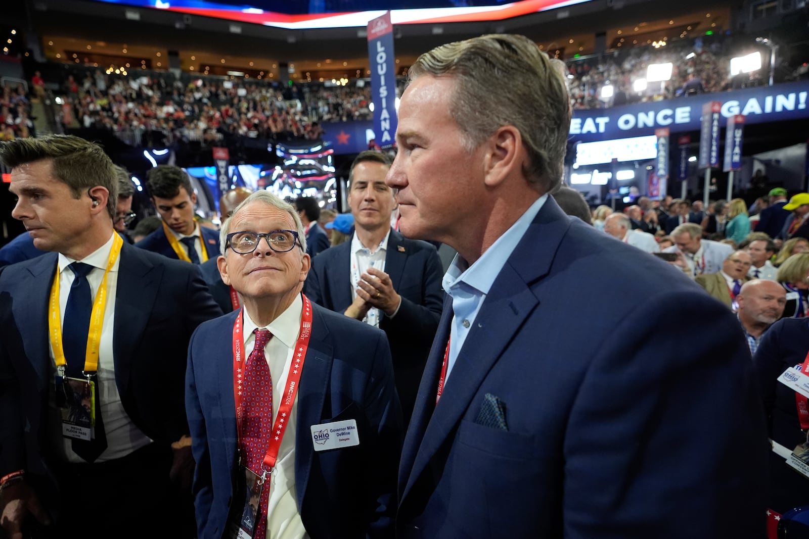 Ohio Gov. Mike DeWine and Lieutenant Gov. Jon Husted react during the Republican National Convention Monday, July 15, 2024, in Milwaukee. (AP Photo/Paul Sancya)