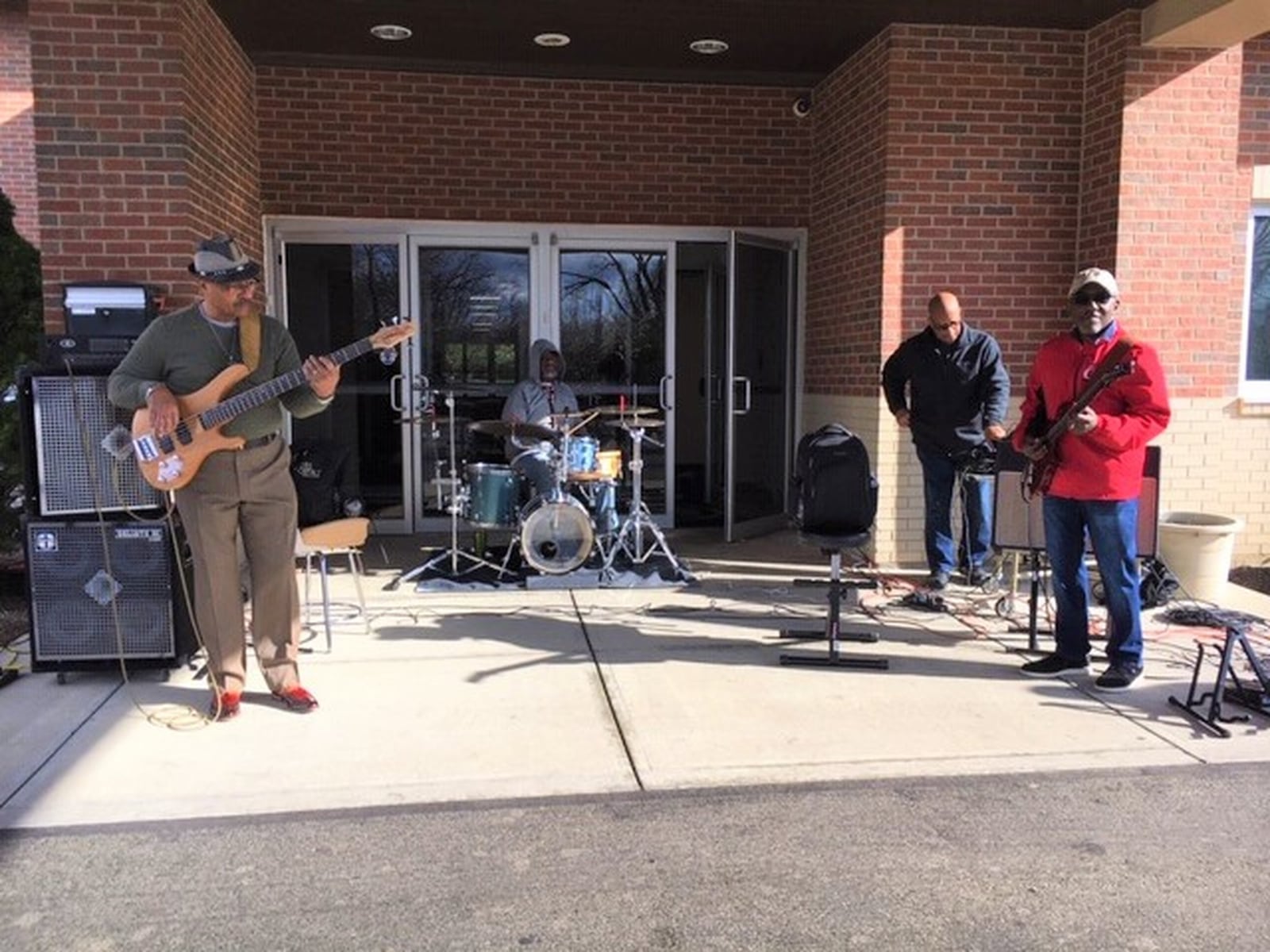 A band warms up before a “worship on wheels” parking lot service Sunday at St. Luke Missionary Baptist Church in Dayton. THOMAS GNAU/STAFF