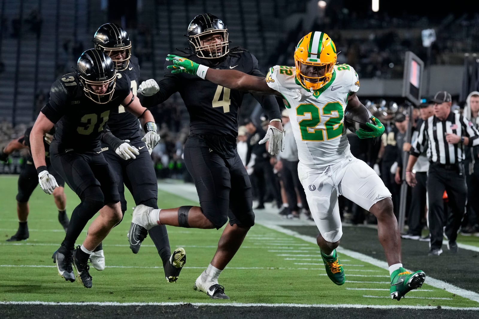 Oregon running back Jay Harris (22) scores a touchdown in front of Purdue linebacker Kydran Jenkins (4) during the second half of an NCAA college football game in West Lafayette, Ind., Friday, Oct. 18, 2024. (AP Photo/AJ Mast)