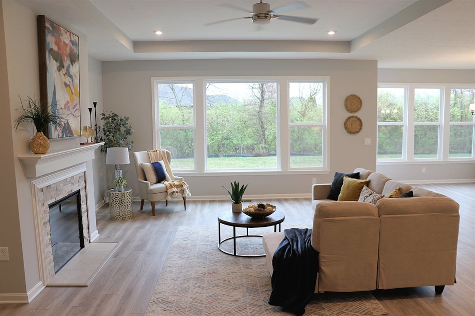 Windows fill the great room with natural light, which is enhanced by canister lighting. 