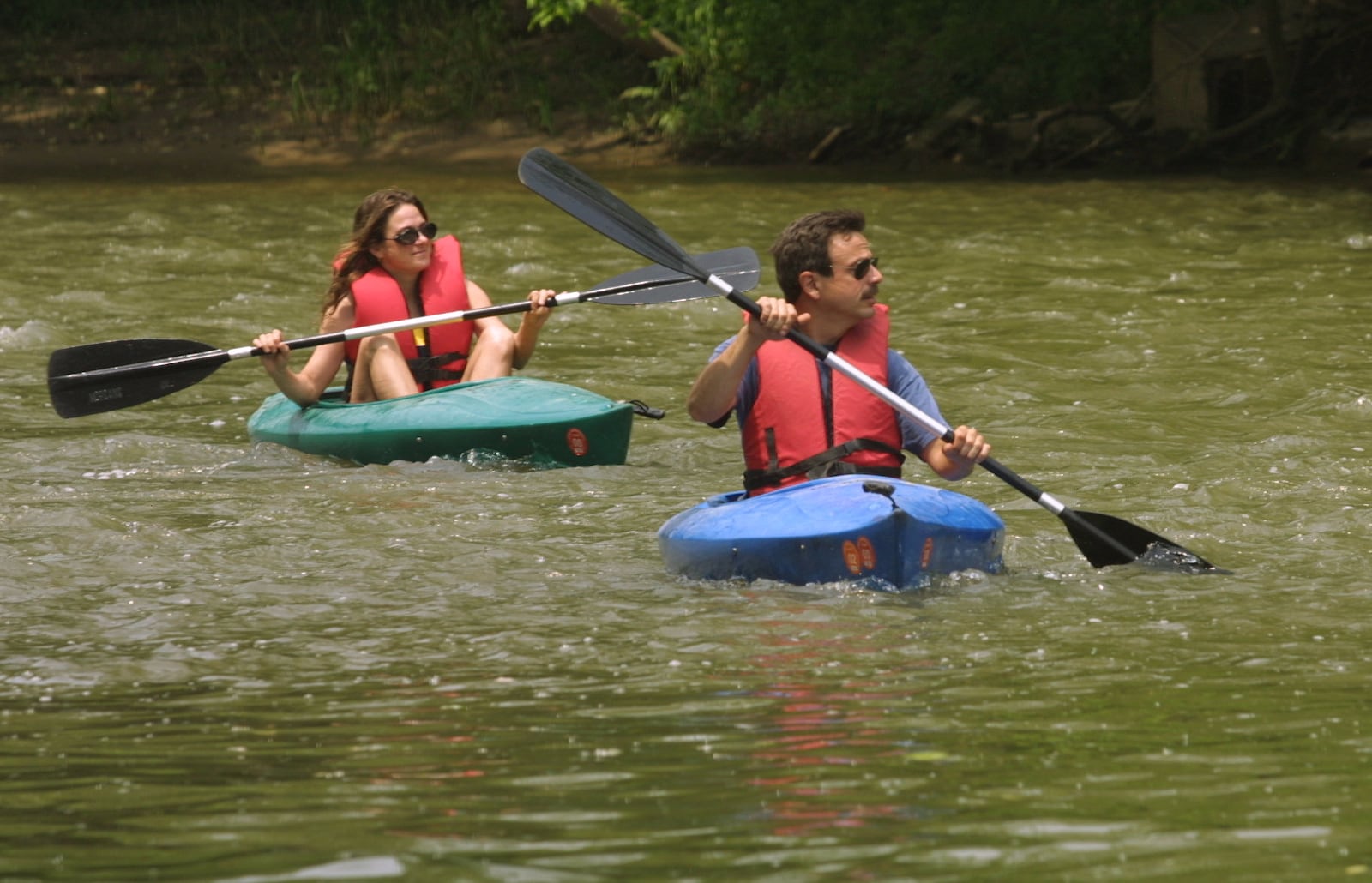 Lori Schultz, left, and Brian Coniglio enjoy a leisurely kayak trip on the Little Miami River.  "Its great.  There is nobody out here," Coniglio said.  "I'm ready for more," Schultz added.  TY GREENLEES / STAFF