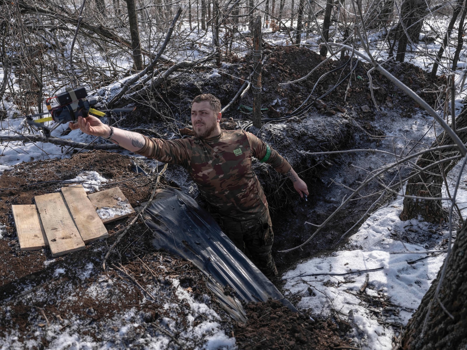 In this photo provided by Ukraine's 93rd Mechanized Brigade press service, a Ukrainian soldier launches a drone from a shelter in partially occupied Toretsk, the site of heavy battles with the Russian troops in the Donetsk region, Ukraine, Saturday, Feb. 22, 2025. (Iryna Rybakova/Ukraine's 93rd Mechanized Brigade via AP)