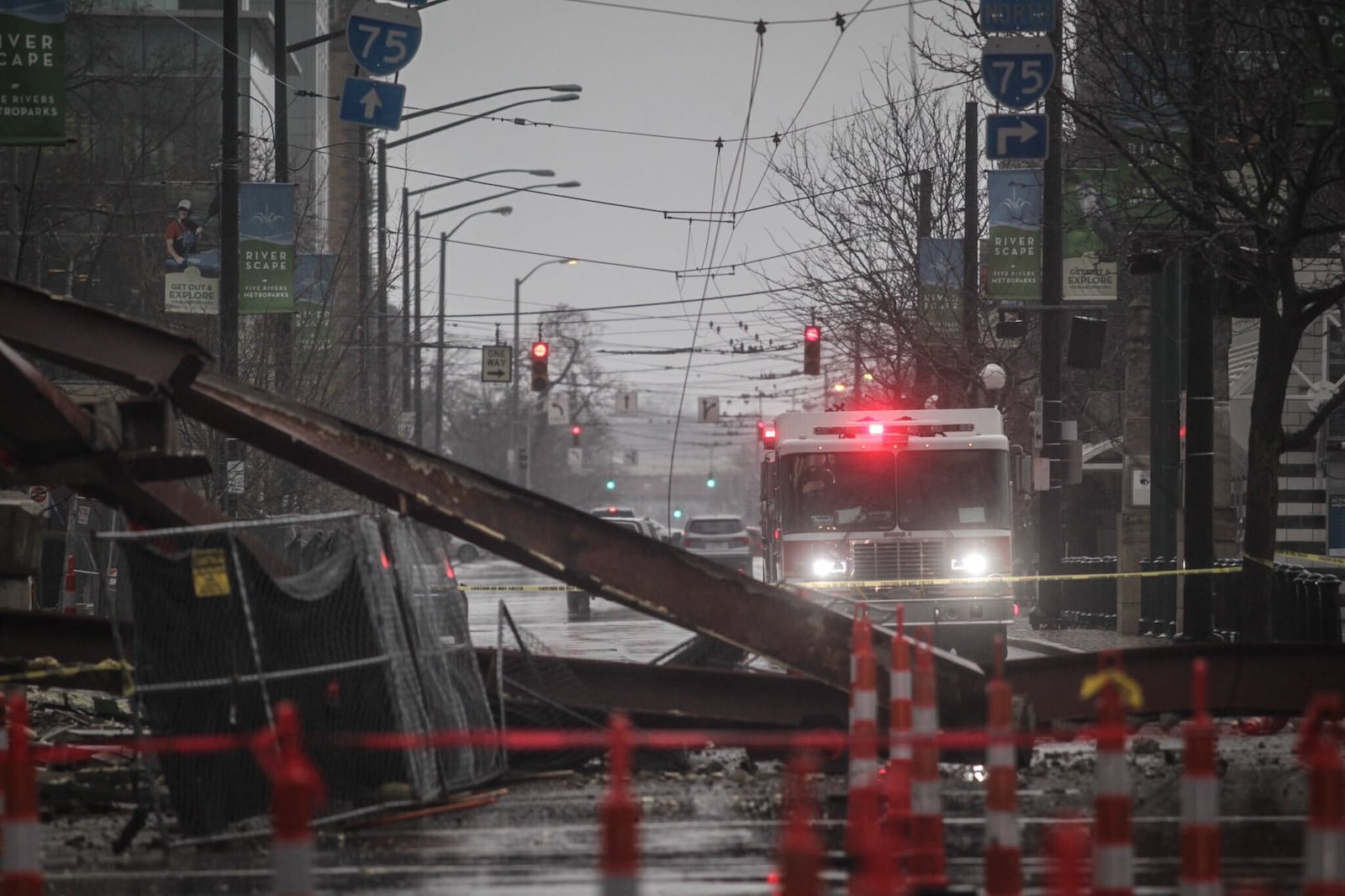 Large metal beams, bricks, concrete and other building debris collapses on East Monument Avenue during a demolition mishap Monday, Dec. 21, 2020, of the former Wright State University Kettering Center in downtown Dayton. JIM NOELKER/STAFF