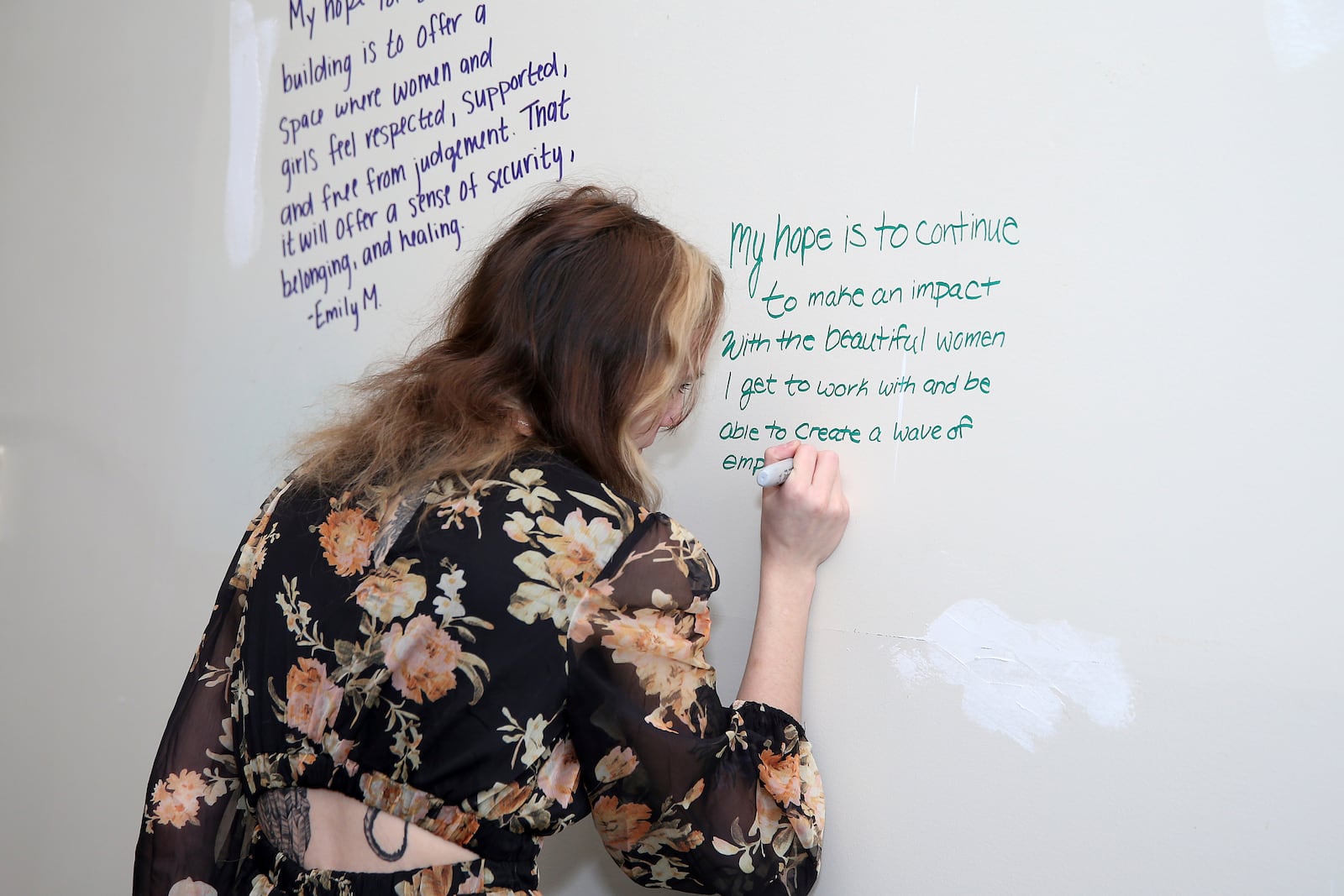 Ireland Daugherty writes her hopes for Libera on the wall Hope Wall at Libera in Morgantown, W.Va., Thursday, Feb., 6 2025. (AP Photo/Kathleen Batten)