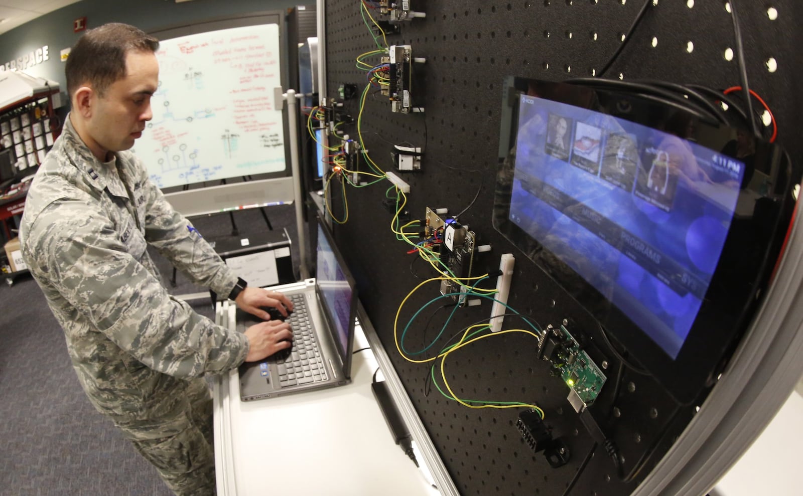 Graduate student Capt. Eddie Caberto is studying ways to thwart hacking of vehicle controls with an automobile simulator at the Center for Cyber Research at the Air Force Institute of Technology, Wright-Patterson Air Force Base. TY GREENLEES / STAFF